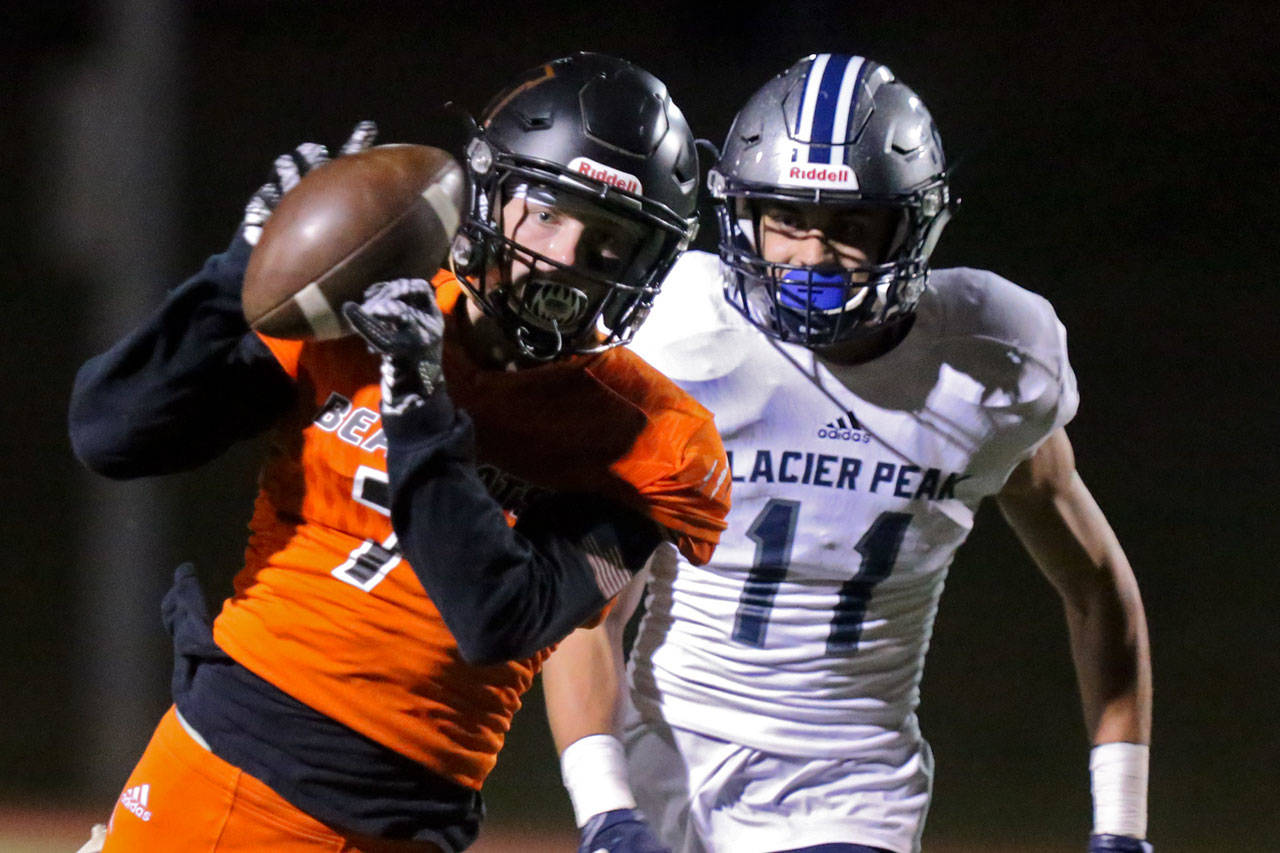 Monroe’s Efton Chism III hauls in a reception with Glacier’s Peak Dawson Crosby trailing during the Bearcats’ 57-0 shutout of the Grizzlies in a Wesco 4A matchup Friday in Monroe. (Kevin Clark / The Herald)