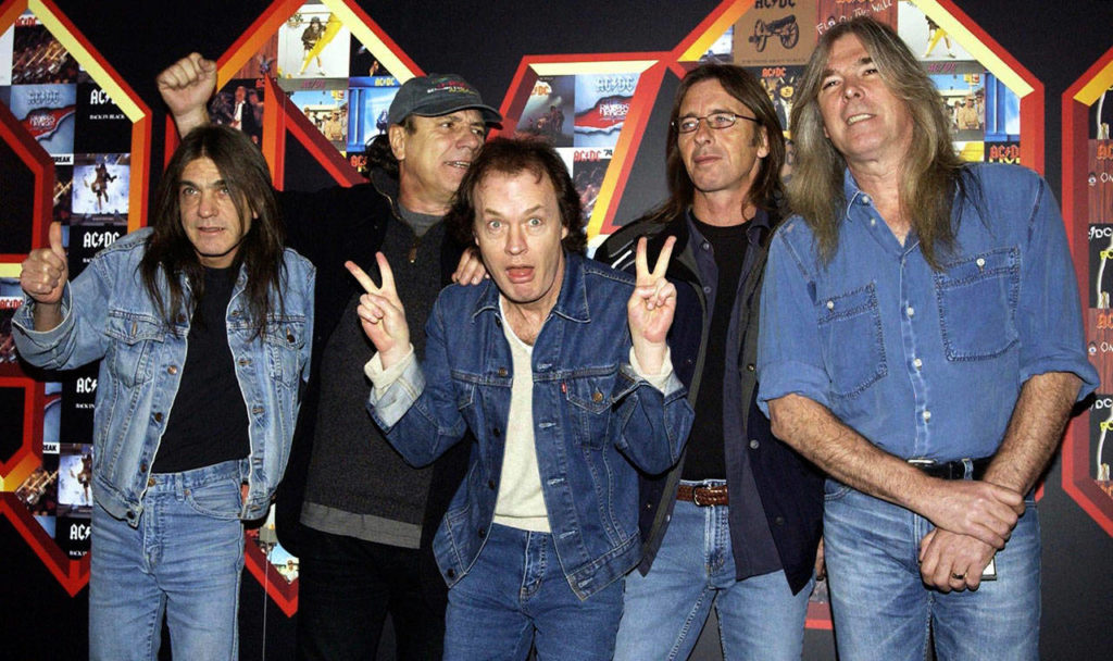 A March 3, 2003 file photo of from left: Malcolm Young, Brian Johnson, Angus Young, Phil Rudd and Cliff Williams from AC/DC posing for photographers at the Apollo Hammersmith in London. The band has announced, Saturday Nov. 18, 2017, that 64-year-old Young has died. (Yui Mok/PA via AP)
