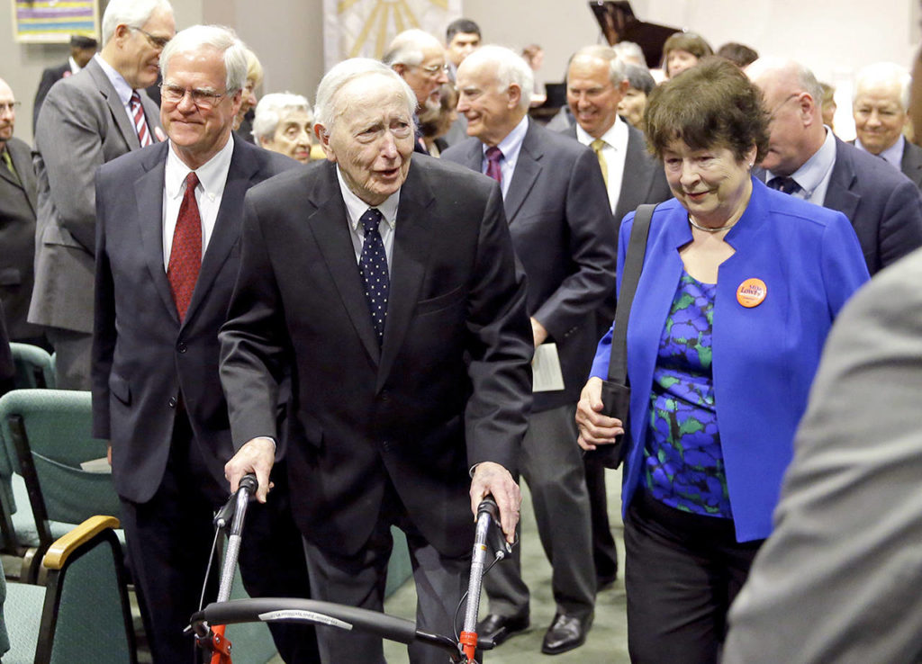 This May 30, 2017 photo shows former Washington Gov. John Spellman (second from left) and Sen. Maralyn Chase, D-Edmonds (in blue), leaving a memorial service in Renton. (AP Photo/Ted S. Warren, File)
