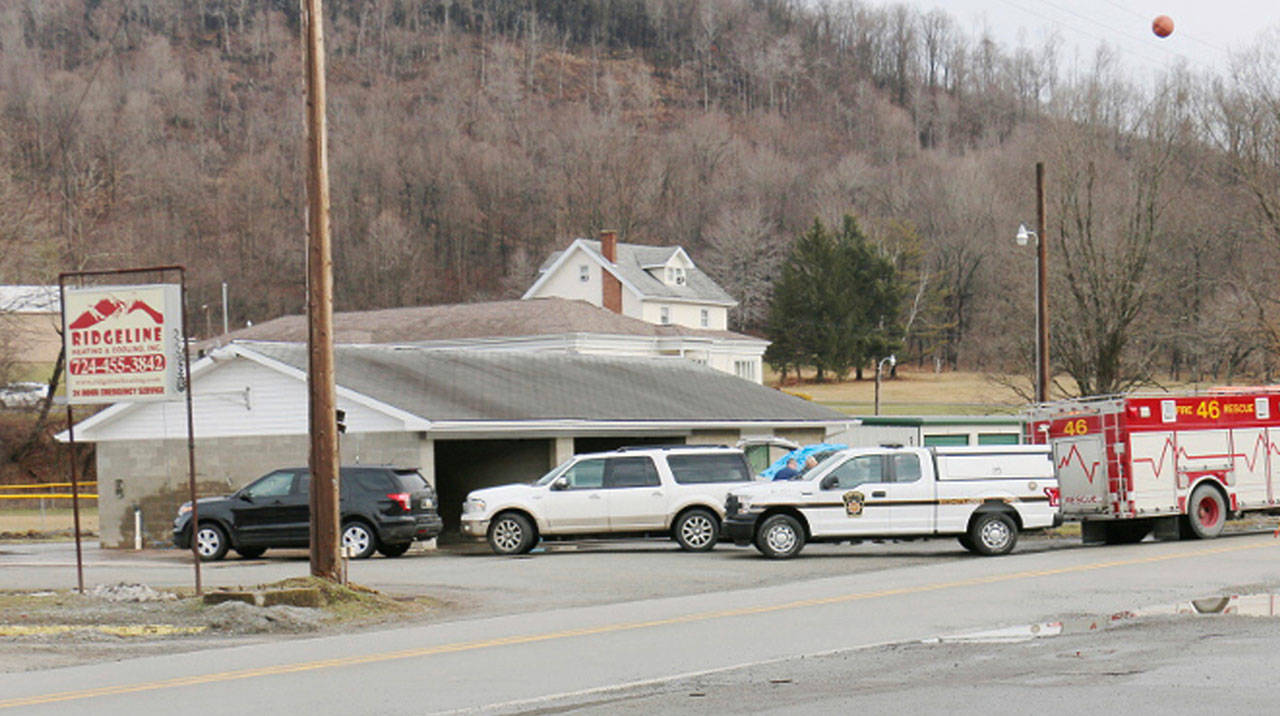 Officers work on the scene of a fatal shooting at a car wash in Melcroft, Pa., Sunday, Jan. 28, 2018. (Michael Palm / Herald-Standard via AP)