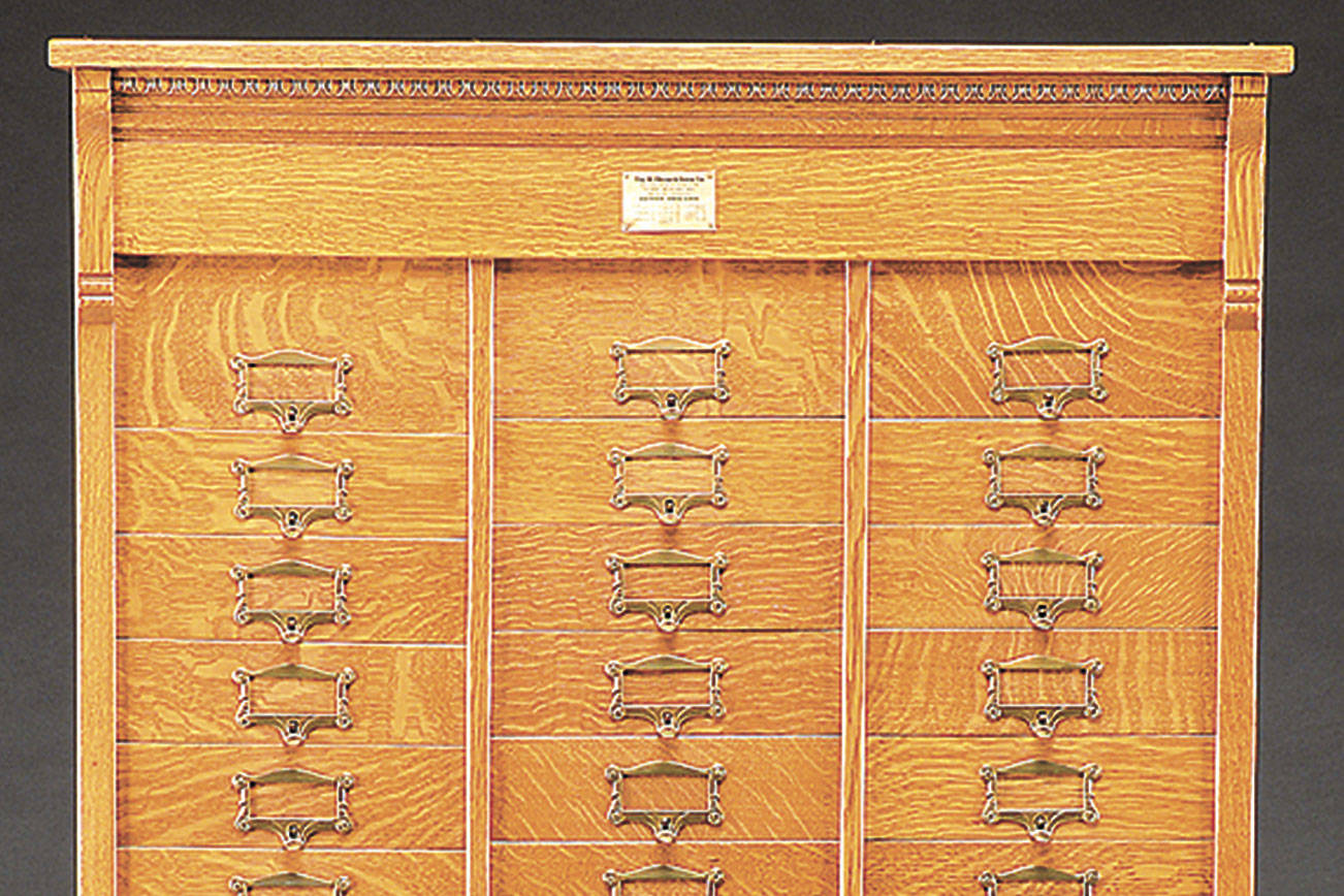 This antique filing cabinet has 48 drawers for lateral files ...