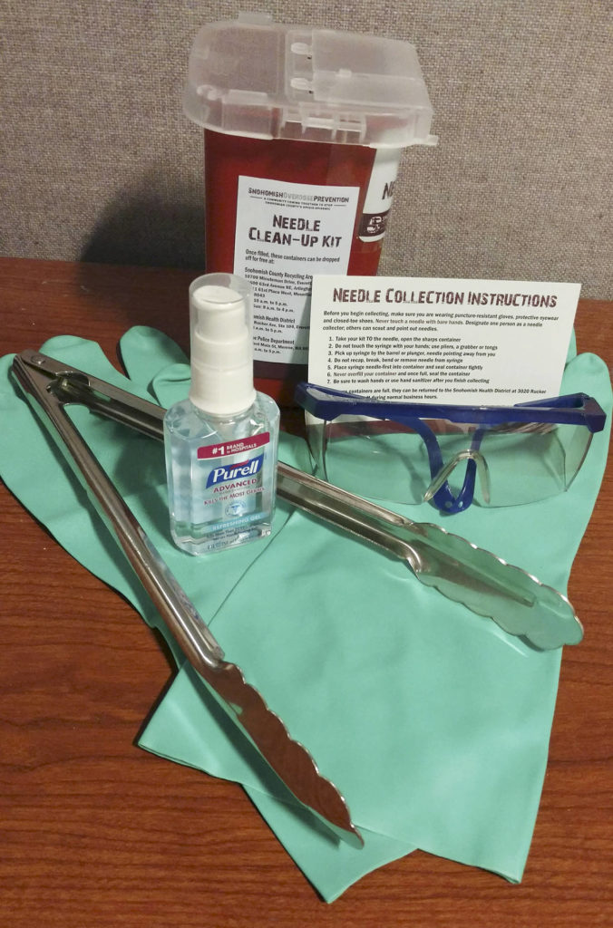 The needle clean-up kits include a container for the syringes, puncture-proof gloves, safety glasses, tongs, hand sanitizer and instructions. (Kari Bray / The Herald)
