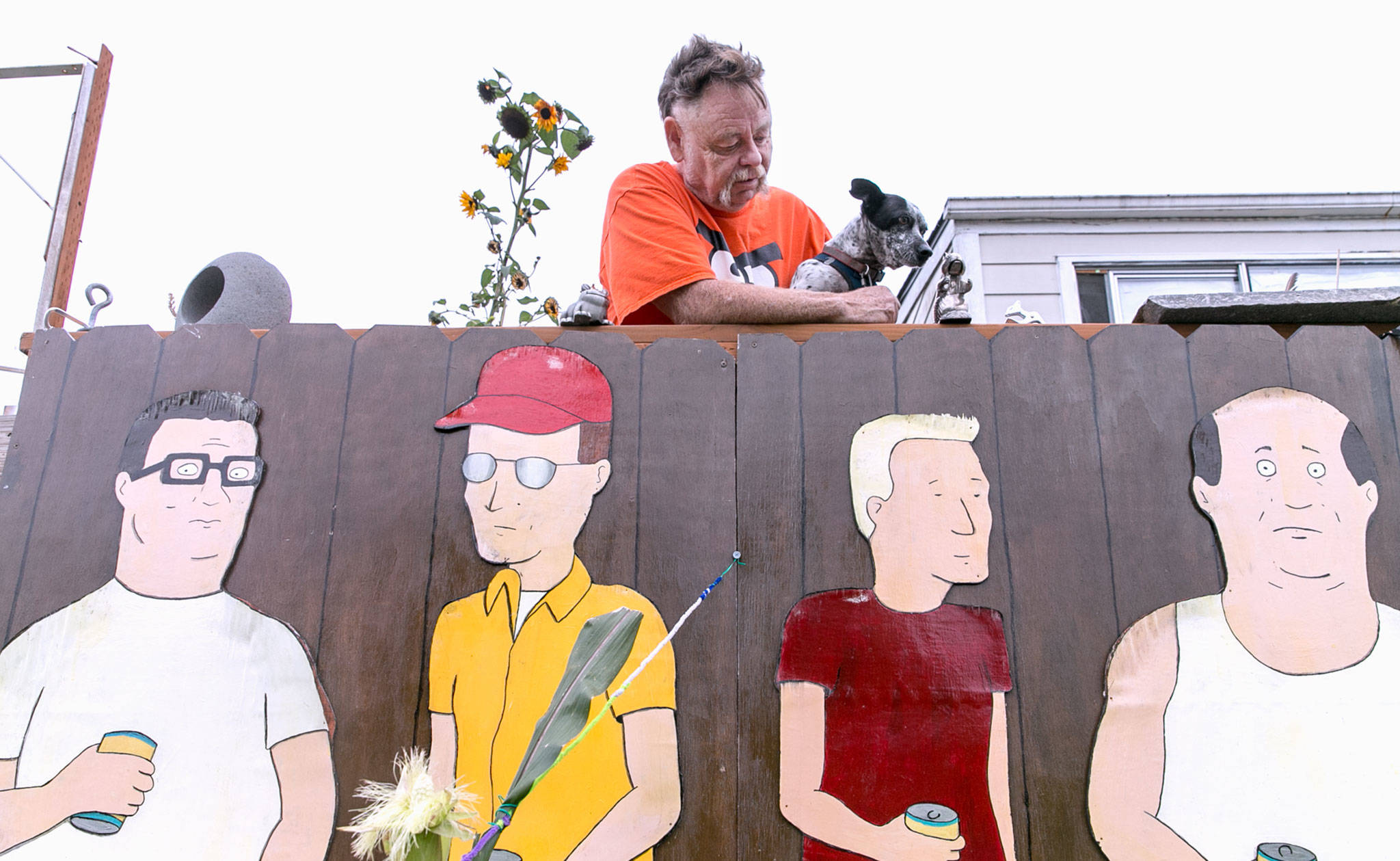 Why are there 'King of the Hill' figures in the front yard?