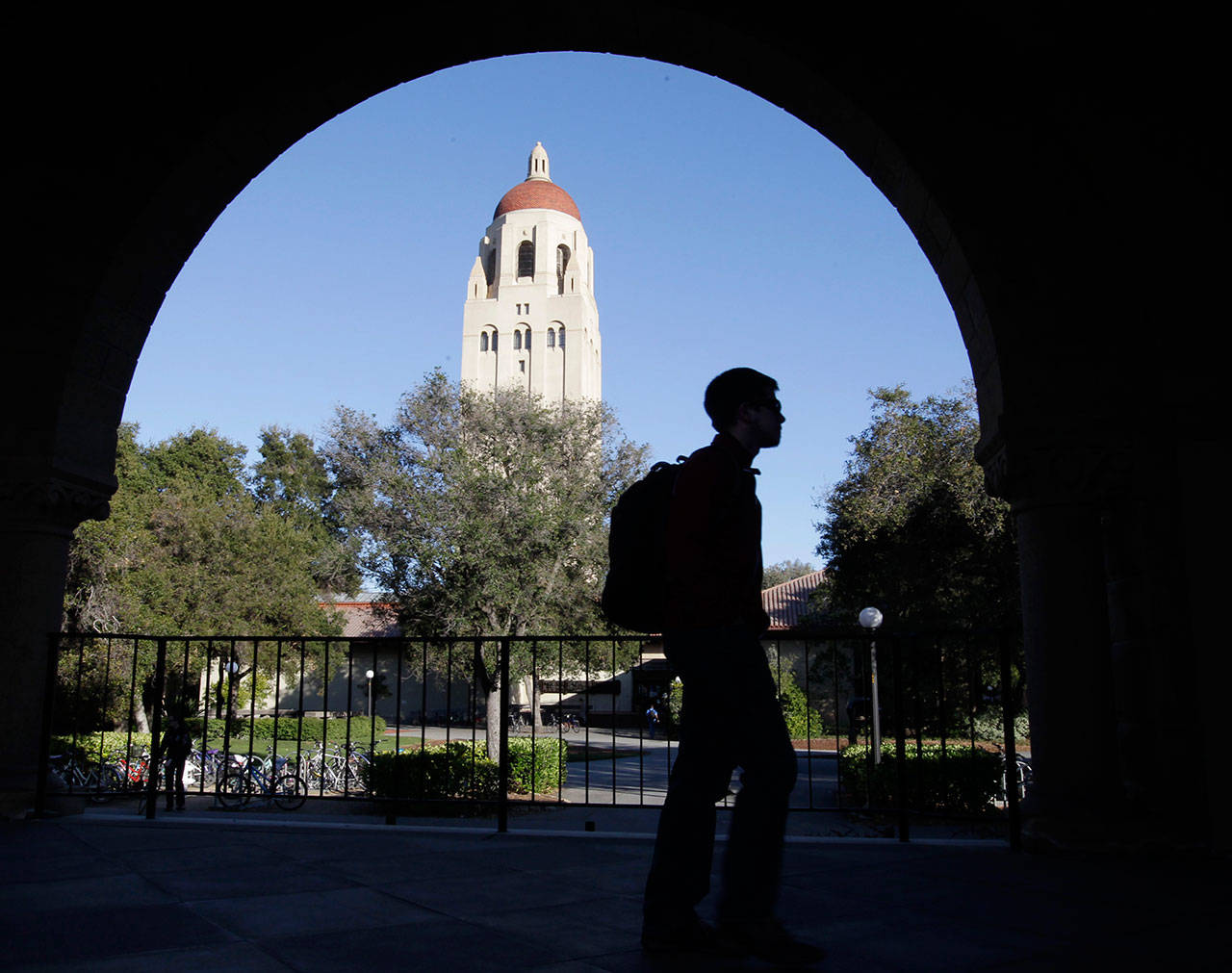 A Stanford University student walks in front of Hoover Tower on the Stanford University campus in Palo Alto, California in February, 2012. Federal authorities have charged college coaches and others in a sweeping admissions bribery case in federal court. The racketeering conspiracy charges were unsealed March 12, against coaches at schools including Stanford, Wake Forest, Georgetown, the University of Southern California and the University of Southern California and University of California, Los Angeles. (Paul Sakuma / Associated Press)