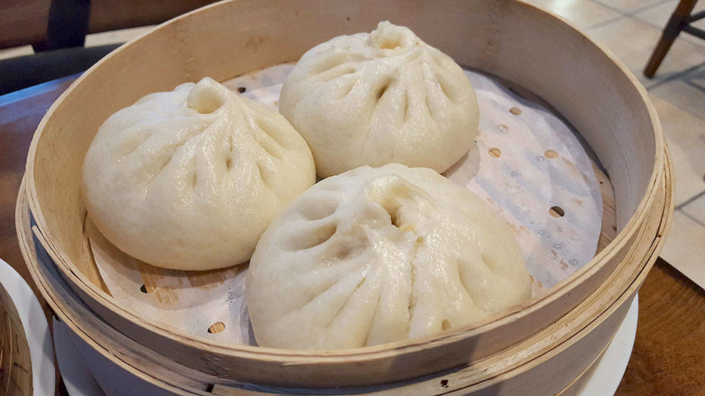 Pork buns are essentially oversized dumplings, but come with a thicker, bread-like texture. (Evan Thompson / The Herald)
