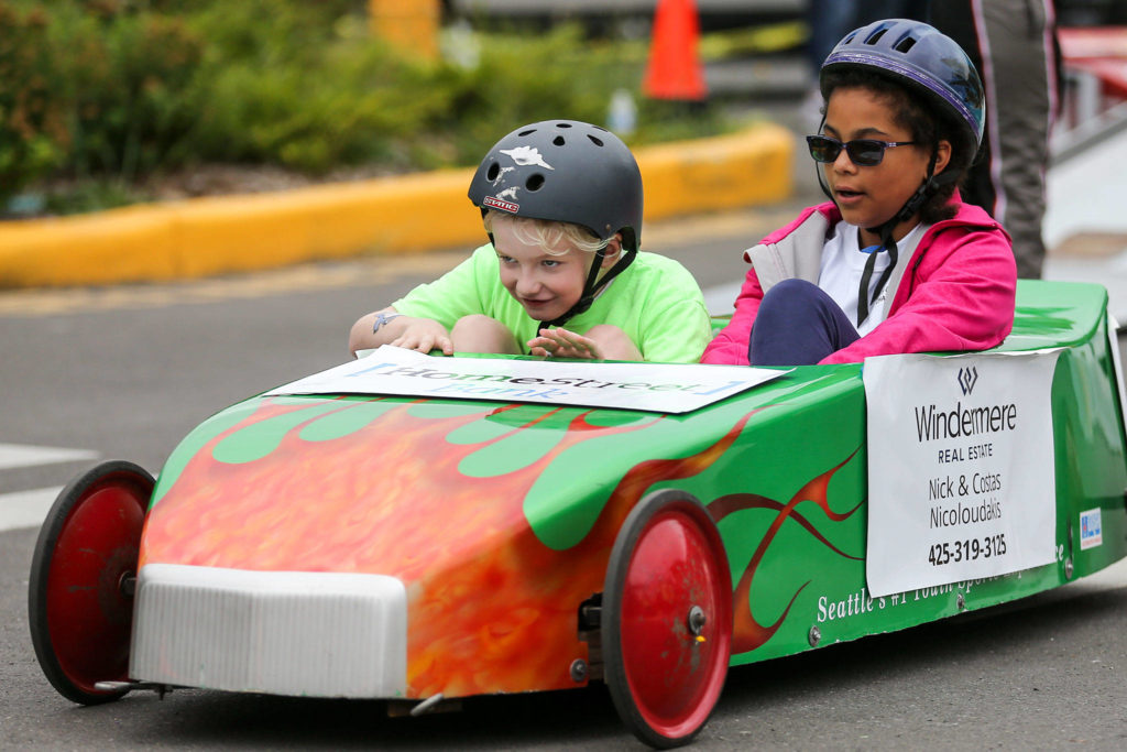 Kian Snider (left) and Lauren Lemkaw ride their gravity car Saturday morning during Challenge Race 2019 at Lynnwood Elementary School. (Kevin Clark / The Herald)
