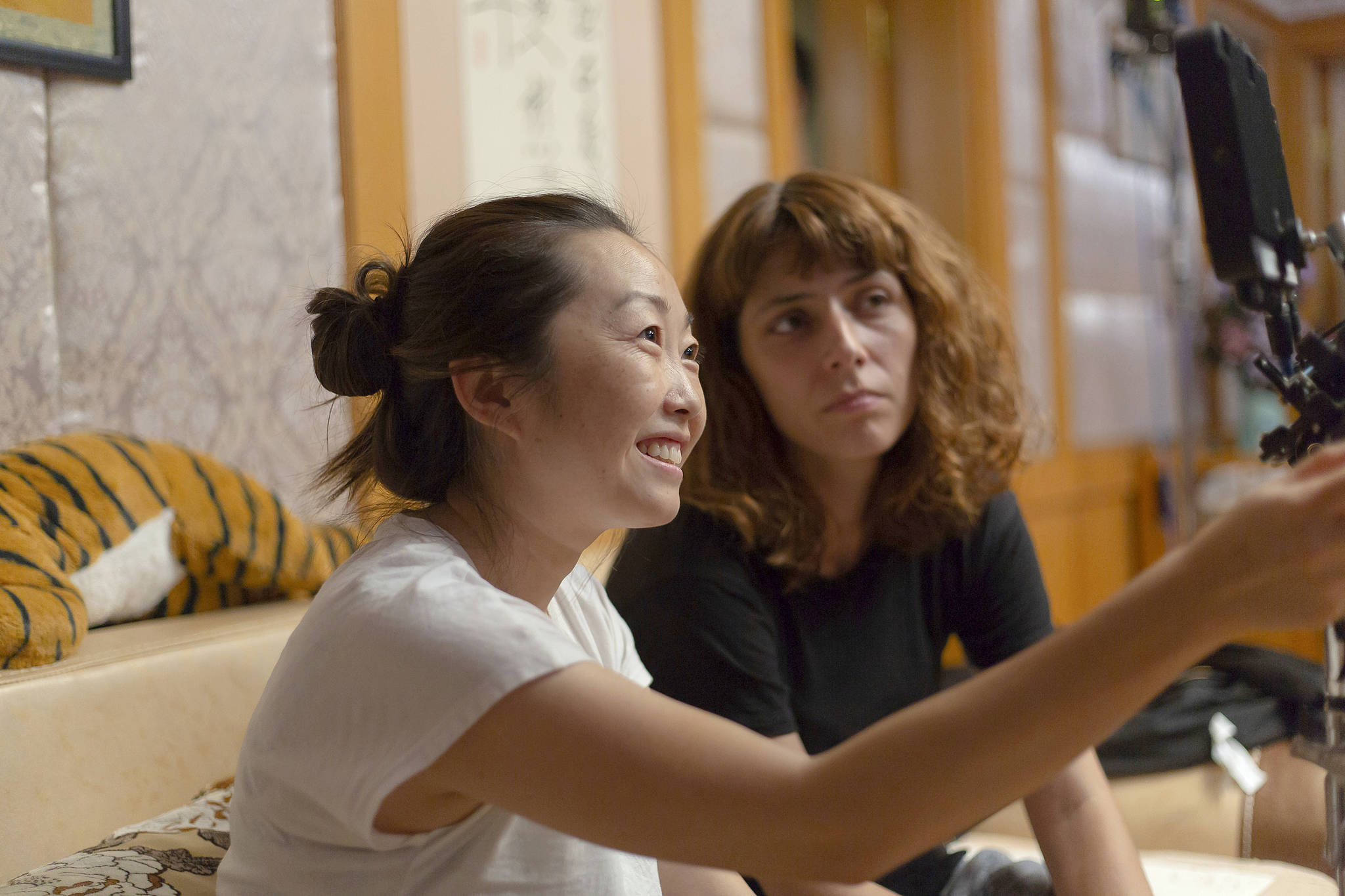 Director Lulu Wang (left) works on the set of “The Farewell.” (Casi Moss/A24 via AP)