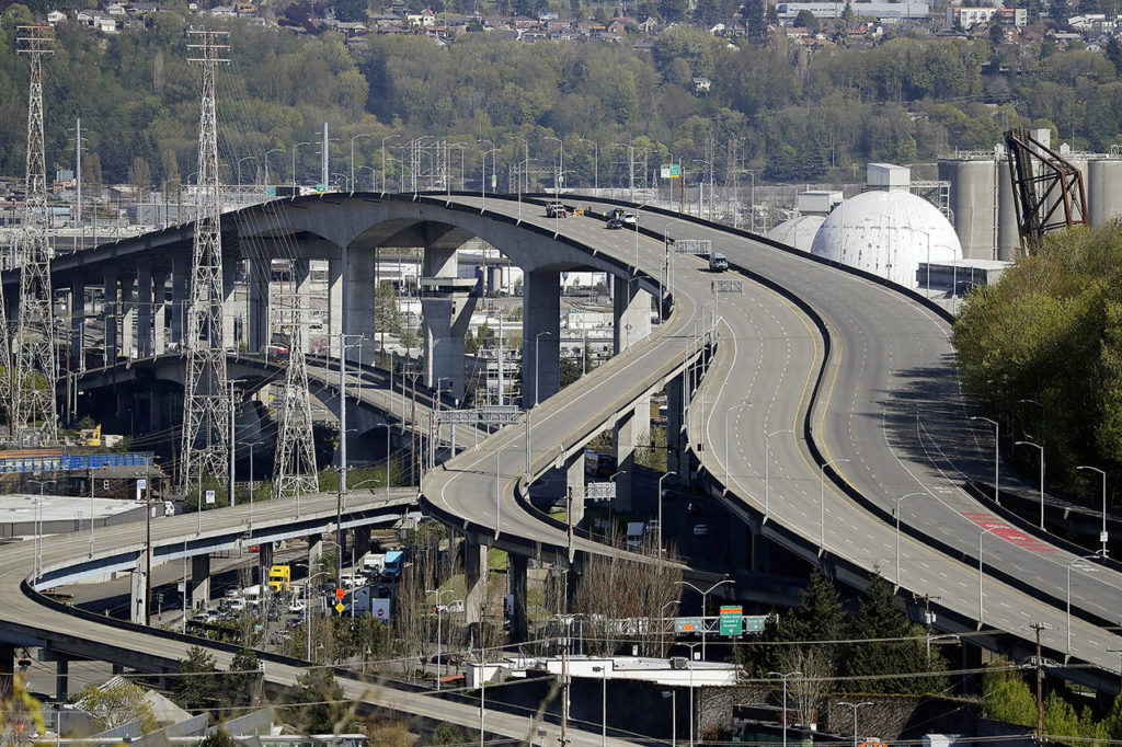 Several work vehicles are parked atop the West Seattle Bridge following an emergency closure several weeks earlier, on April 15 in Seattle. (AP Photo/Elaine Thompson, file)
