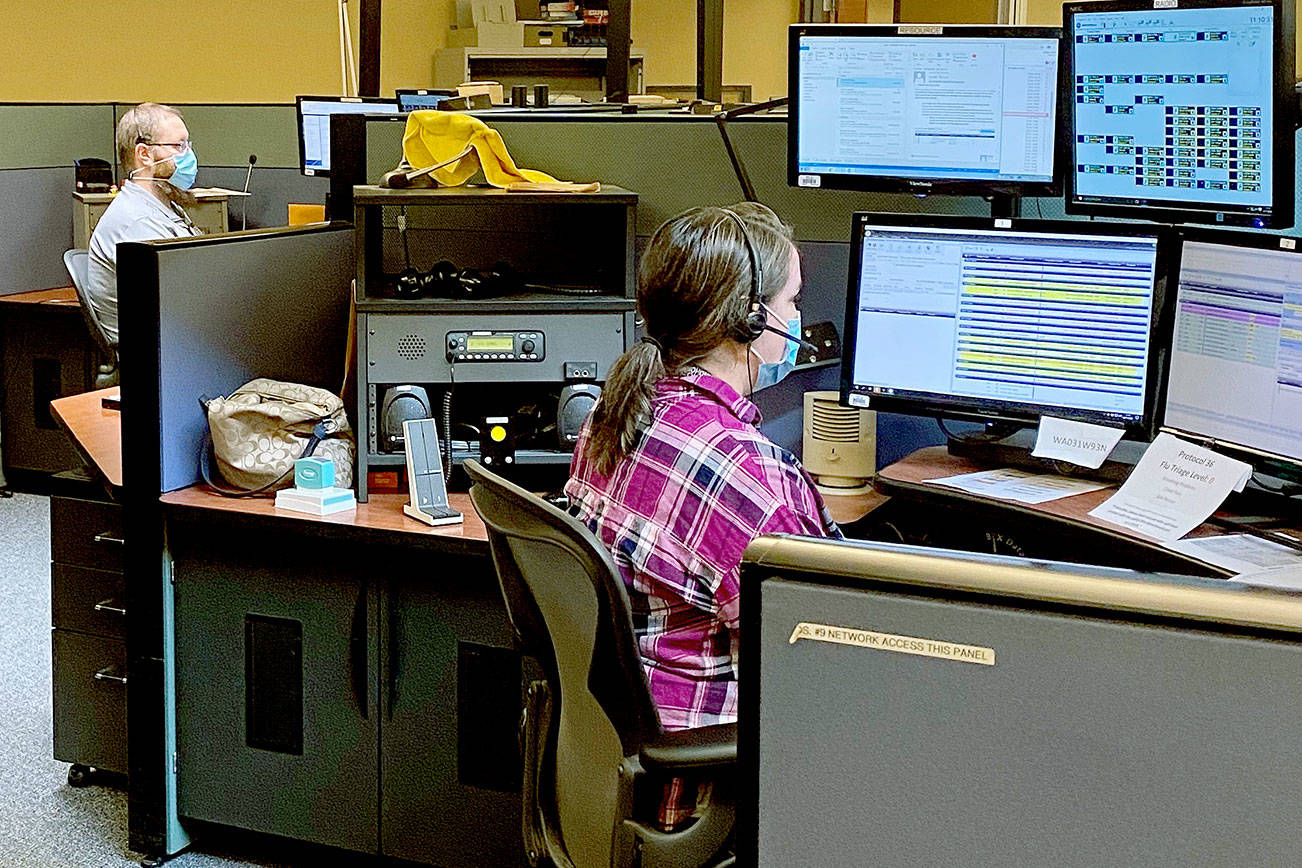 Like almost all workplaces in 2010, masks are now the norm at Snohomish County 911 due to COVID-19. Dispatchers have been split into two campuses to increase distance between workers. (Courtesy of Snohomish County 911.)