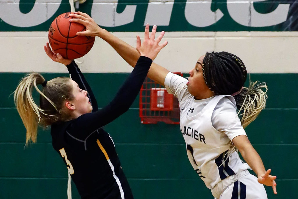 Glacier Peak’s Aaliyah Collins blocks the shot of Inglemoor’s Lucy Young during a game at Jackson High School in Mill Creek on Feb. 18, 2020. (Kevin Clark / The Herald)
