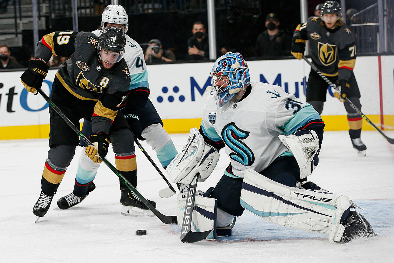 Seattle Kraken goaltender Philipp Grubauer (31) blocks the puck in front of Vegas Golden Knights right wing Reilly Smith (19) during the second period of an NHL hockey game Tuesday, Oct. 12, 2021, in Las Vegas. (AP Photo/Chase Stevens)