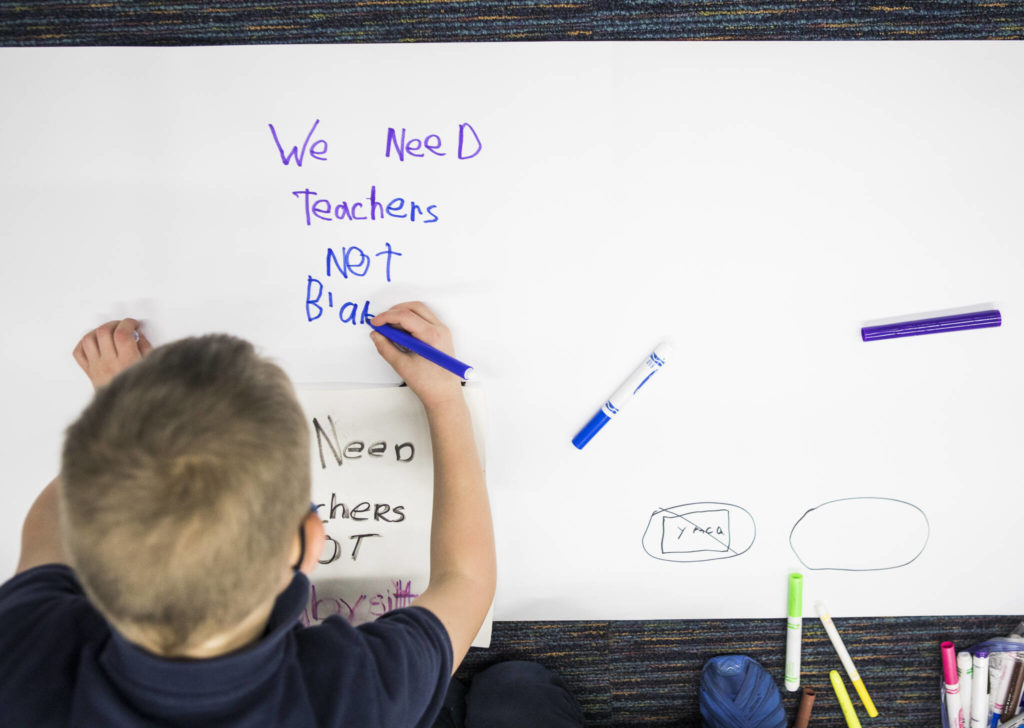 Kids write down their thoughts about the proposed closing of the Early Learning Center. (Olivia Vanni / The Herald) 
