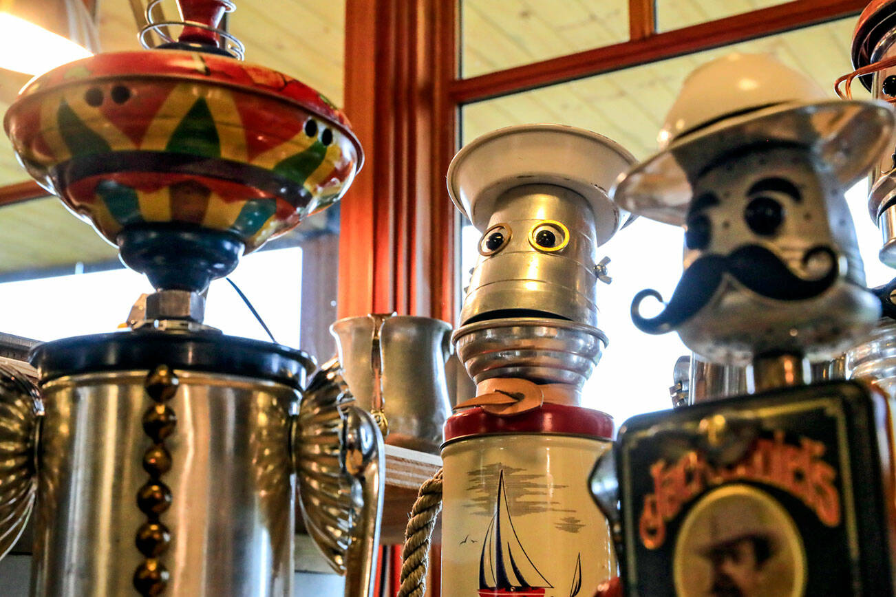 Various vintage androids that are created from up-cycled, repurposed and recycled kitchenware, coffee kettles and other metals by Amy Knutson at her home workshop in of Everett, Washington.  (Kevin Clark / The Herald)