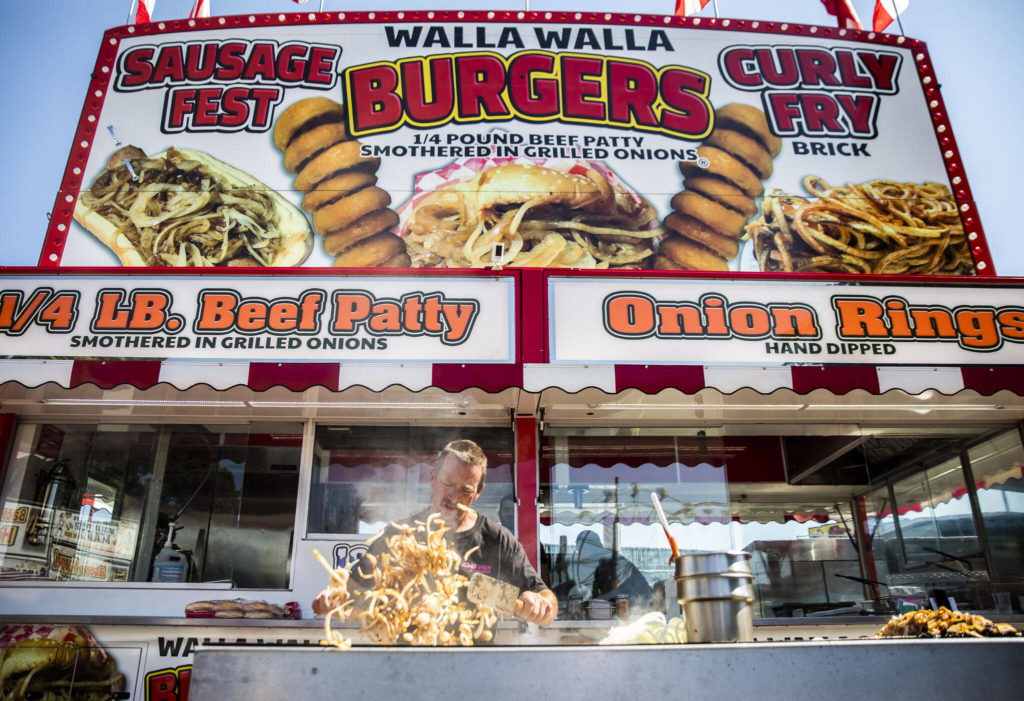 The aroma of grilled onions beckons fairgoers to the Walla Walla Burger booth. (Olivia Vanni / The Herald)
