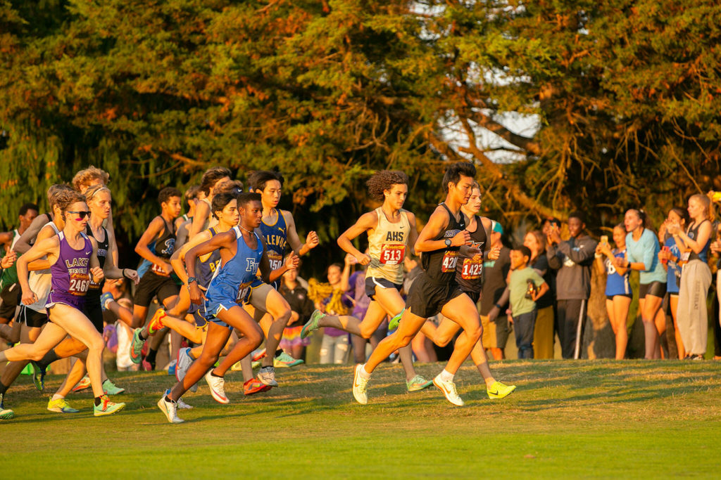 The 3A-4A Boys 5K takes off during the Nike Twilight Cross Country Invitational on Saturday, Oct. 1, 2022, at Cedarcrest Golf Course in Marysville, Washington. (Ryan Berry / The Herald)
