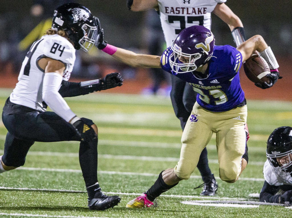 Lake Stevens receiver David Brown stiff-arms an Eastlake defender. (Olivia Vanni / The Herald)
