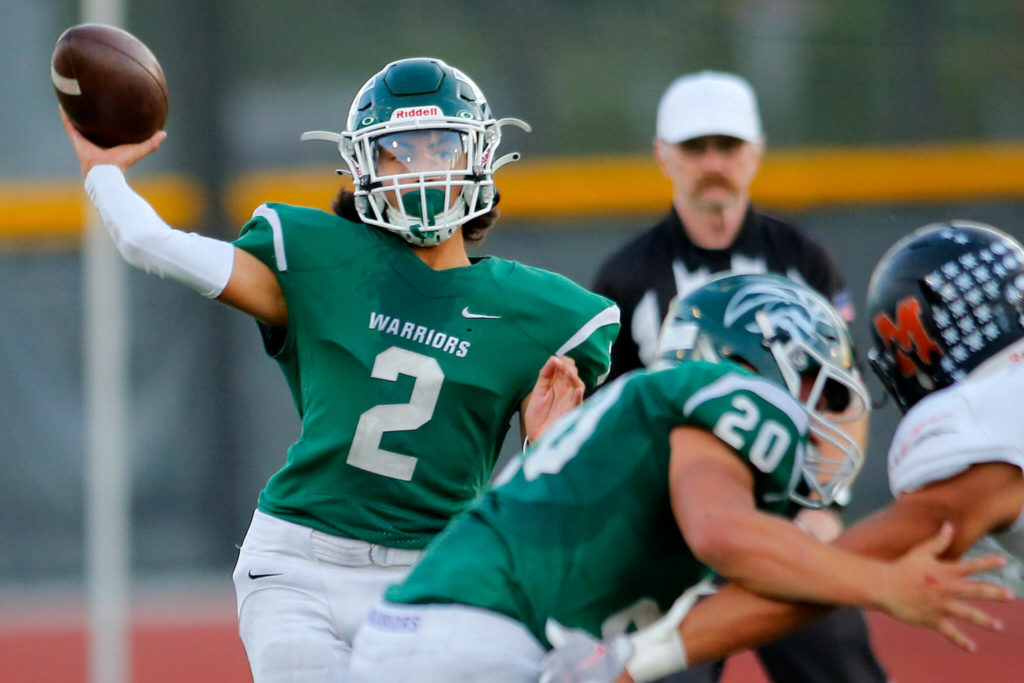 Edmonds-Woodway backup quarterback Diego Escandon throws a short screen pass against Monroe on Oct. 14 at Edmonds Stadium. (Ryan Berry / The Herald)
