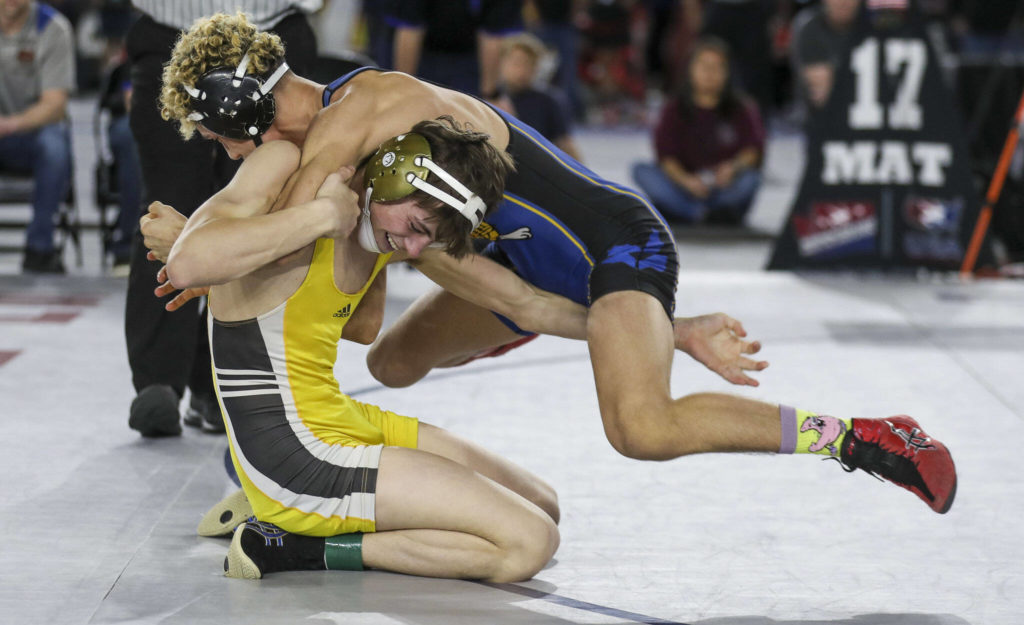 Darrington’s Aksel Espeland and Tonasket’s Aaron Polito wrestle during the 1B/2B Boys 126-pound championship match during the Mat Classic XXXIV at the Tacoma Dome in Tacoma, Washington on Saturday, Feb. 18, 2023. (Annie Barker / The Herald)
