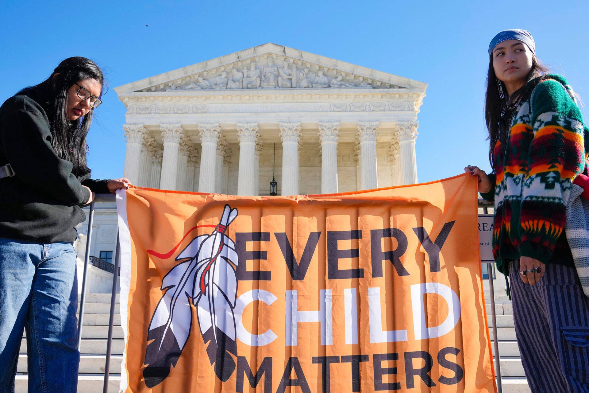 Demonstrators stand outside of the U.S. Supreme Court, as the court hears arguments over the Indian Child Welfare Act on Nov. 9, 2022, in Washington.