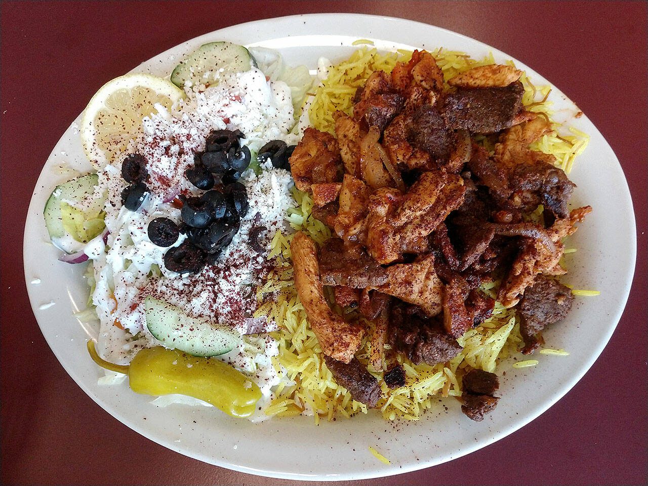 The mixed shawarma platter at Gyro House Mediterranean Cafe in Everett offers chicken, beef, saffron rice and Greek salad for $13.99.  (Sara Bruestle/The Herald) The mixed shawarma plate at Gyro House Mediterranean Cafe in Everett offers chicken, beef, saffron rice and Greek salad for $13.99.  (Sarah Brustle/Herald)