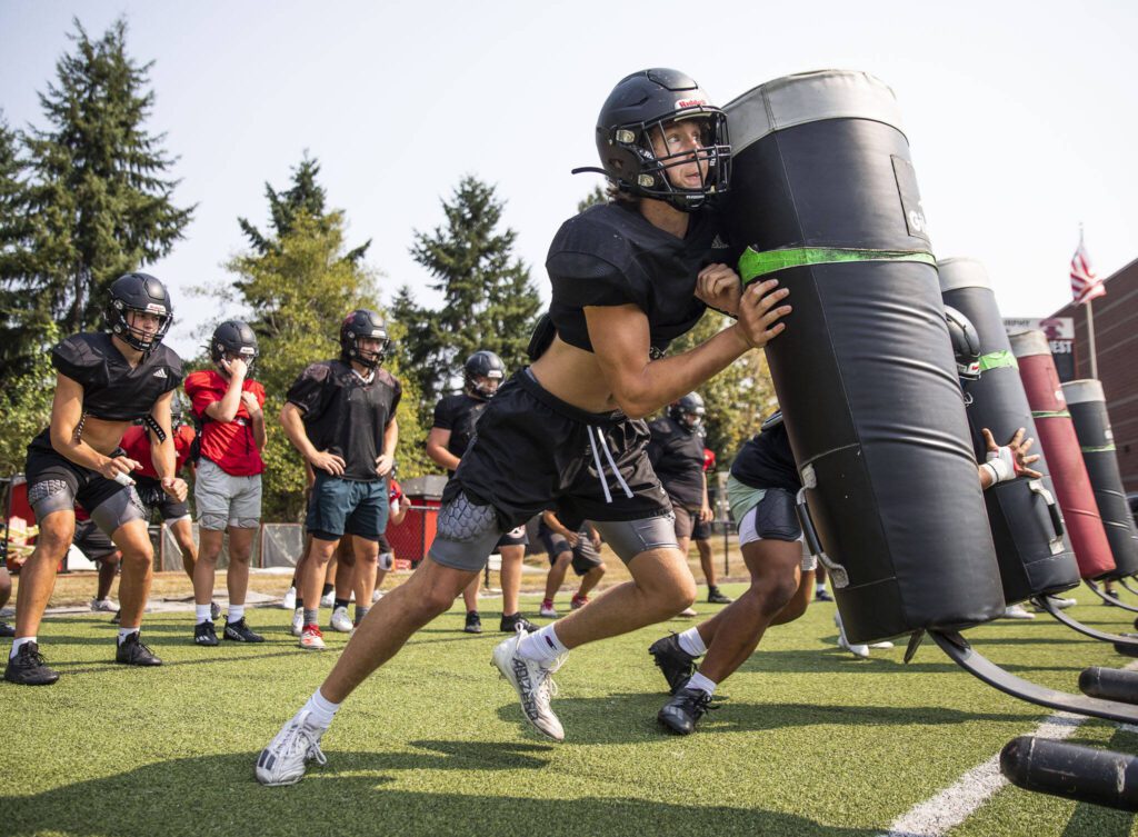 Archbishop Murphy’s Ryder Burkett pushes a sled during practice on Thursday, Aug. 24, 2023 in Everett, Washington. (Olivia Vanni / The Herald)
