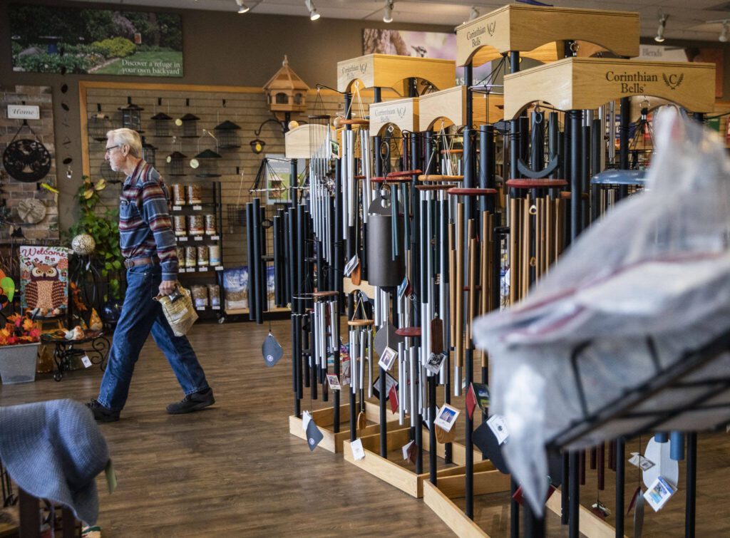 A customer walks out with a bag of bird seed from Wild Birds Unlimited on Monday, Oct. 23, 2023 in Everett, Washington. (Olivia Vanni / The Herald)
