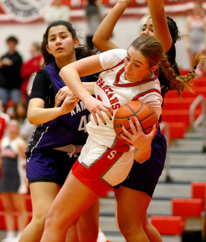 Stanwood’s Ellalee Wortham spins out of trouble with the ball against Kamiak on Thursday, Nov. 30, 2023, at Stanwood High School in Stanwood, Washington. (Ryan Berry / The Herald)
