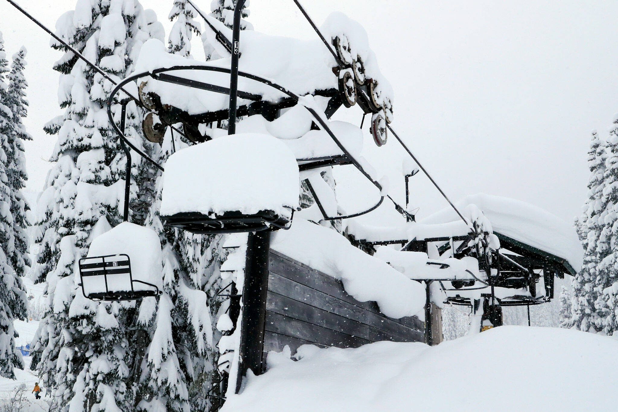 A chair lift sits idle on Stevens Pass Thursday afternoon on December 30, 2021. (Kevin Clark / The Herald)