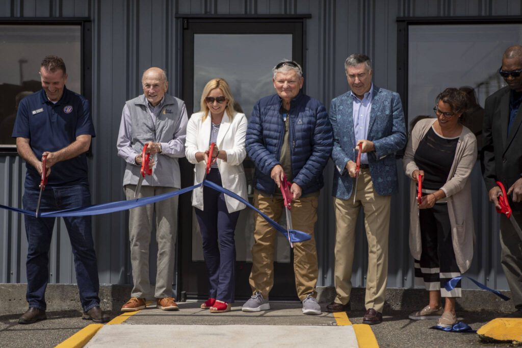 Community members cut a ribbon during a ceremony at the Maritime Institute in Everett, Washington on Wednesday, May 22, 2024. (Annie Barker / The Herald)
