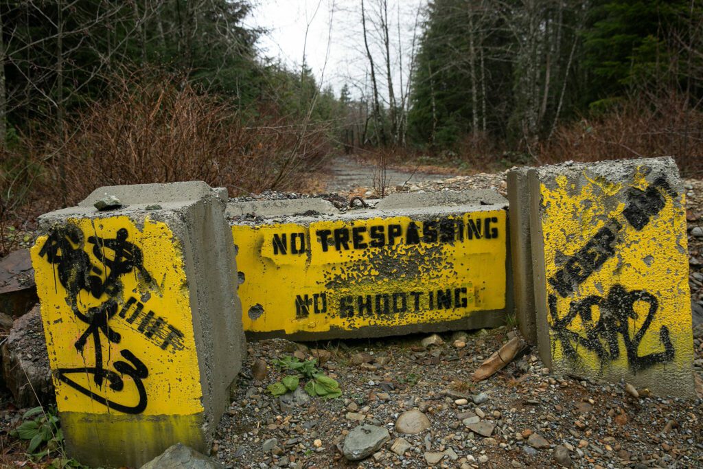 Cement barriers are in place to ward off people trying to use firearms in the area along Sultan Basin Road on Thursday, Feb. 8, 2024, in Sultan, Washington. (Ryan Berry / The Herald)
