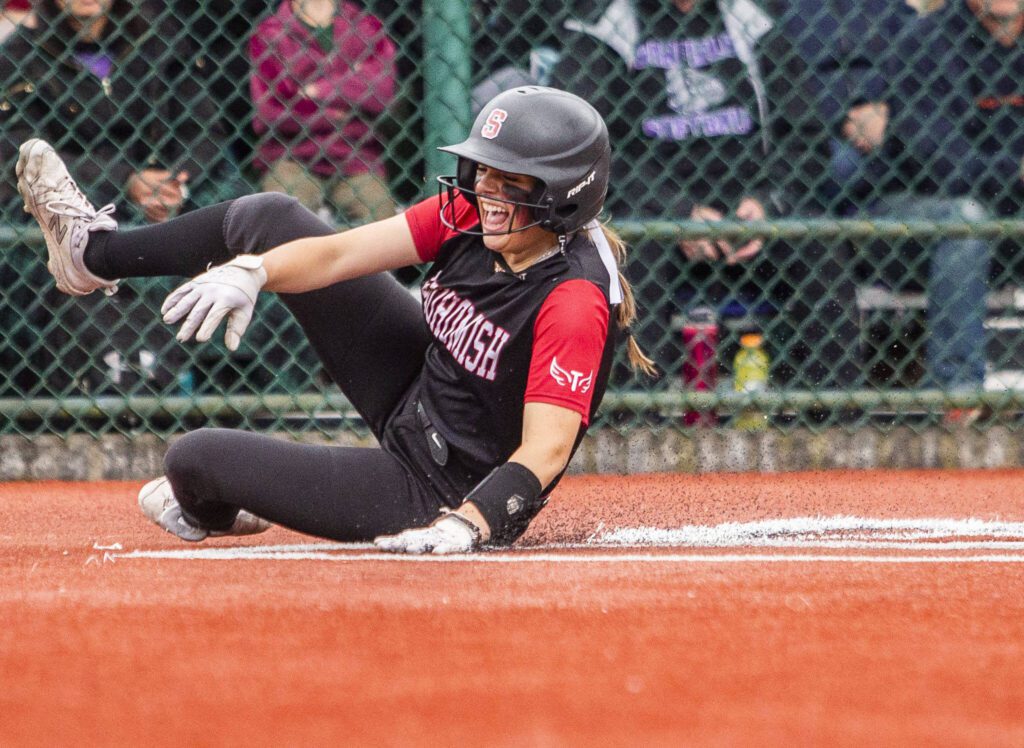 Snohomish’s Alexandra Flohr slides into home to score during the 3A state softball semifinal game against Garfield on Saturday, May 25, 2024 in Lacey, Washington. (Olivia Vanni / The Herald)
