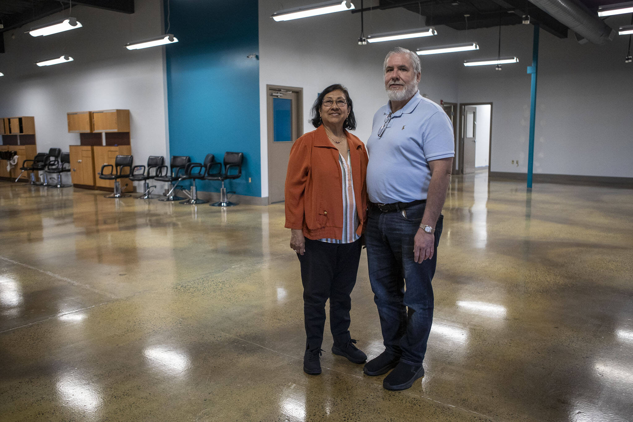 LETI founder and president Rosario Reyes, left, and LETI director of operations Thomas Laing III, right, pose for a photo at the former Paroba College in Everett, Washington on Saturday, June 1, 2024. (Annie Barker / The Herald)