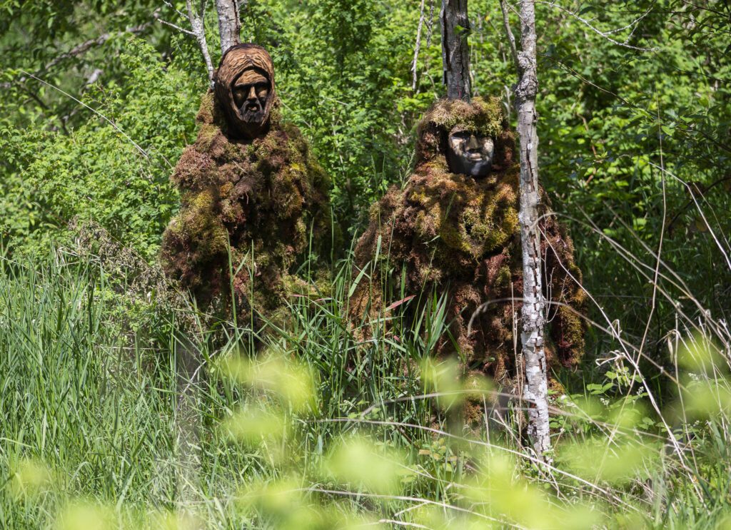 Two new Lake Stevens Bigfoot-Moss Man-Sasquatch along the Stevens Creek stream on Lundeen Parkway in Lake Stevens. (Olivia Vanni / The Herald)
