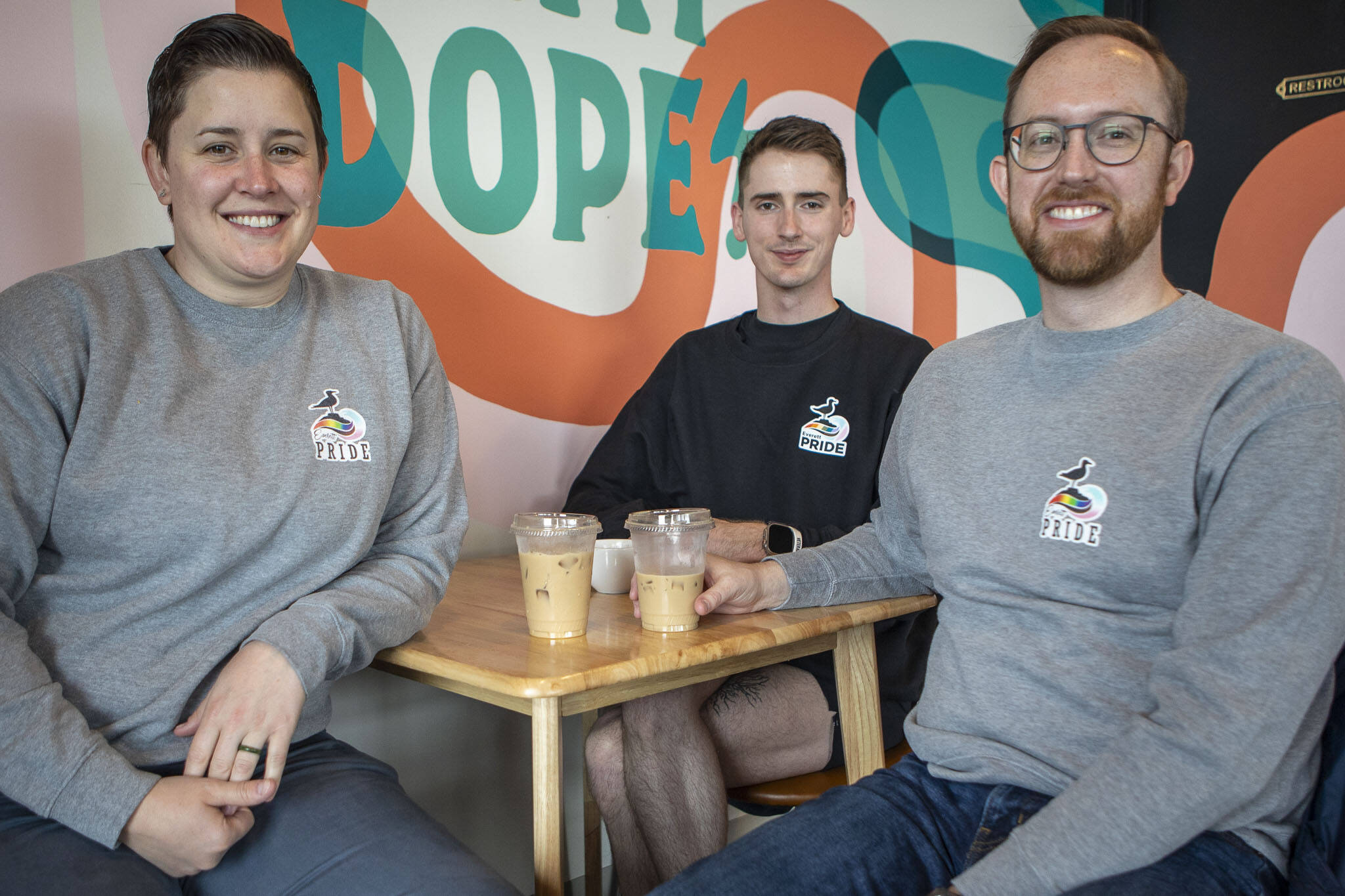 Left to right, Everett Pride board members Ashley Turner, Bryce Laake, and Kevin Daniels pose for a photo at South Fork Bakery in Everett, Washington on Sunday, May 26, 2024. (Annie Barker / The Herald)