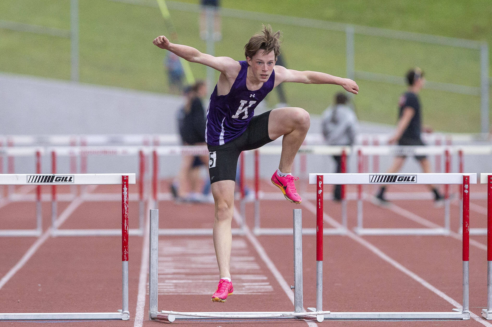 Kamiak’s Miller Warm knocks over the final hurdle before crossing the finish line in the Men’s 300 Meter Hurdles during the Eason Invitational at Snohomish High School on Saturday, April 20, 2024 in Snohomish, Washington. (Olivia Vanni / The Herald)