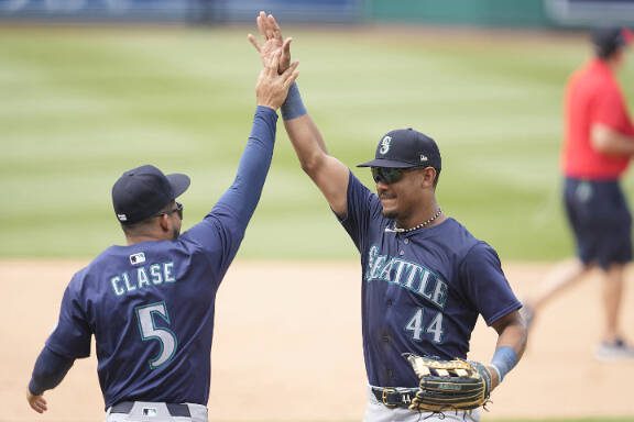 WASHINGTON, DC - MAY 26:  Julio Rodríguez #44 of the Seattle Mariners celebrates a win with Jonathan Clase #5 after a baseball game against the Washington Nationals at Nationals Park on May 26, 2024 in Washington, DC.  (Photo by Mitchell Layton/Getty Images)