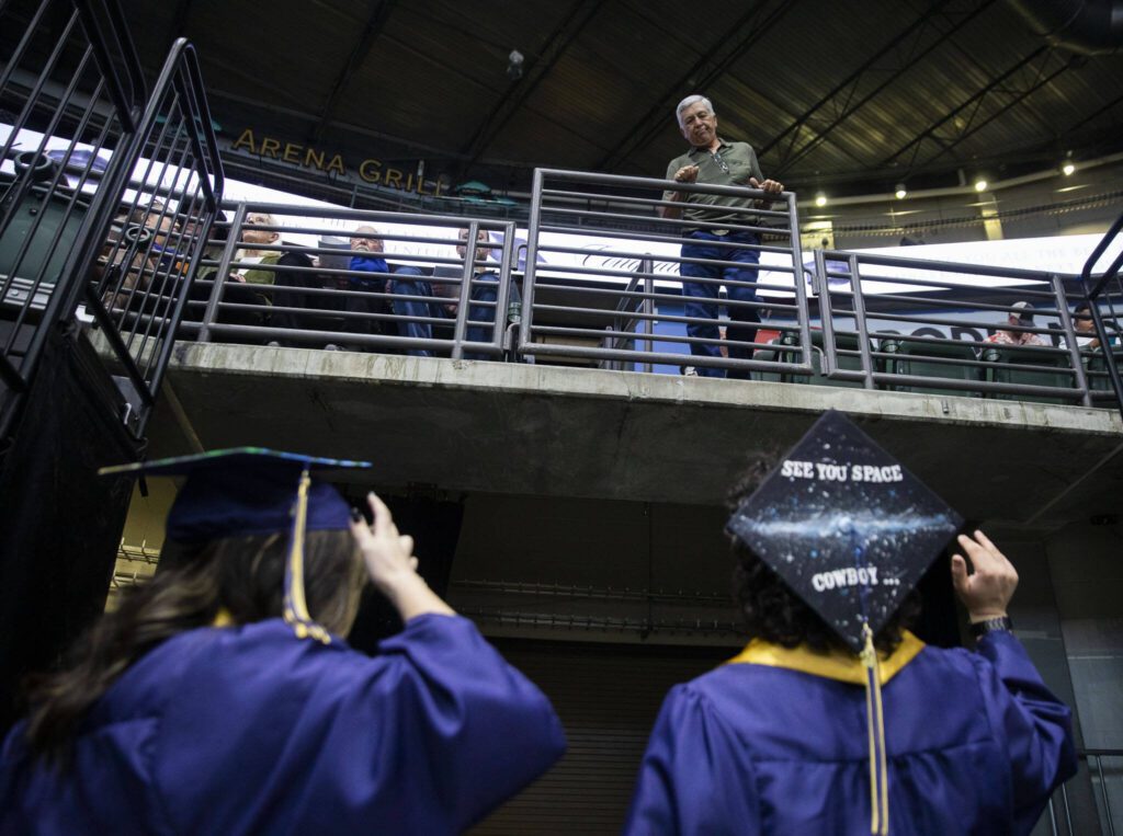 Graduates talk with family members before the start of Arlington High School graduation at Angel of the Winds Arena on Thursday, June 13, 2024, in Everett, Washington. (Olivia Vanni / The Herald)
