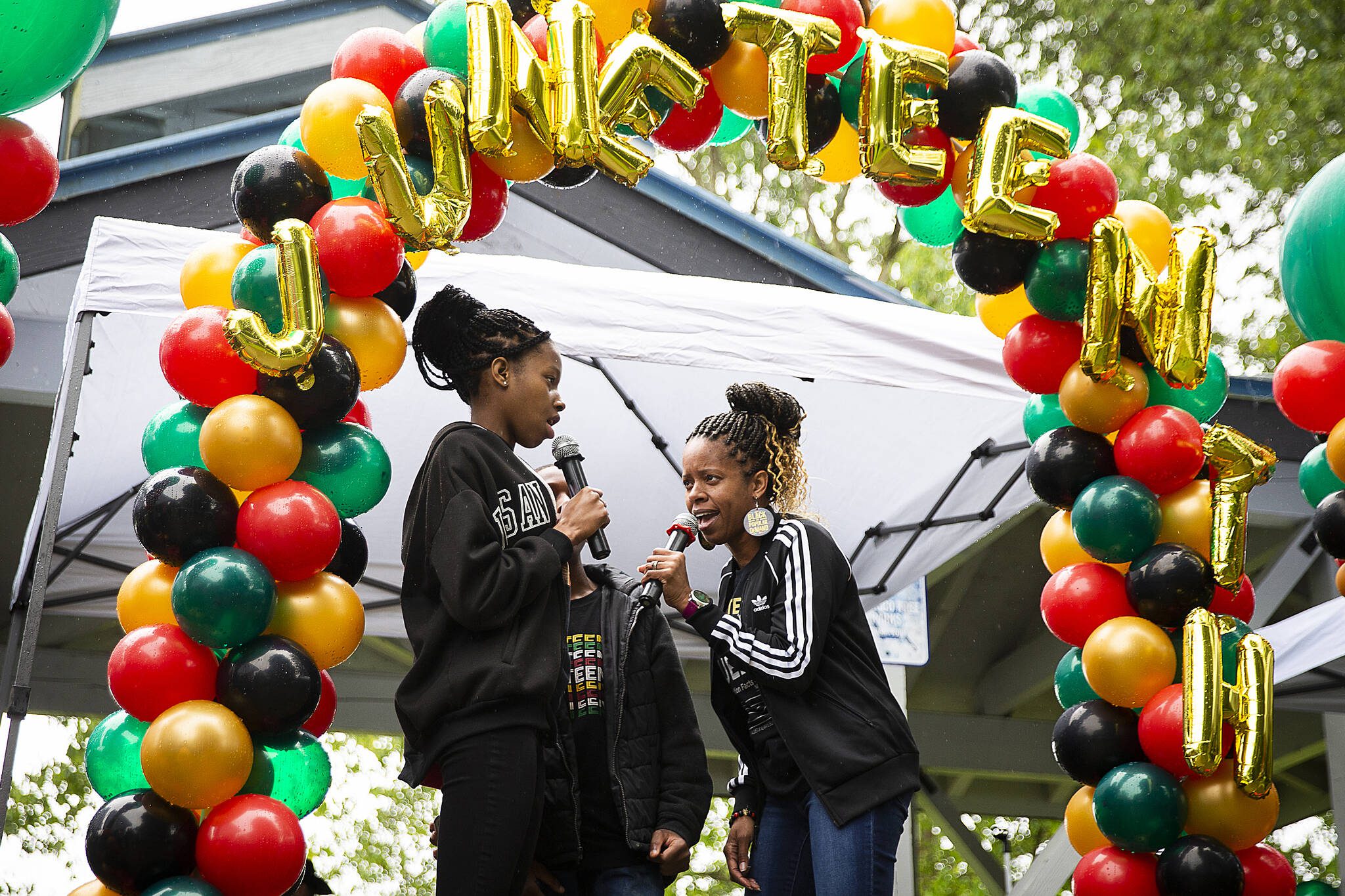 Junelle Lewis, right, daughter Tamara Grigsby and son Jayden Hill sing “Lift Every Voice and Sing” during Monroe’s Juneteenth celebration on Saturday, June 18, 2022. (Olivia Vanni / The Herald)