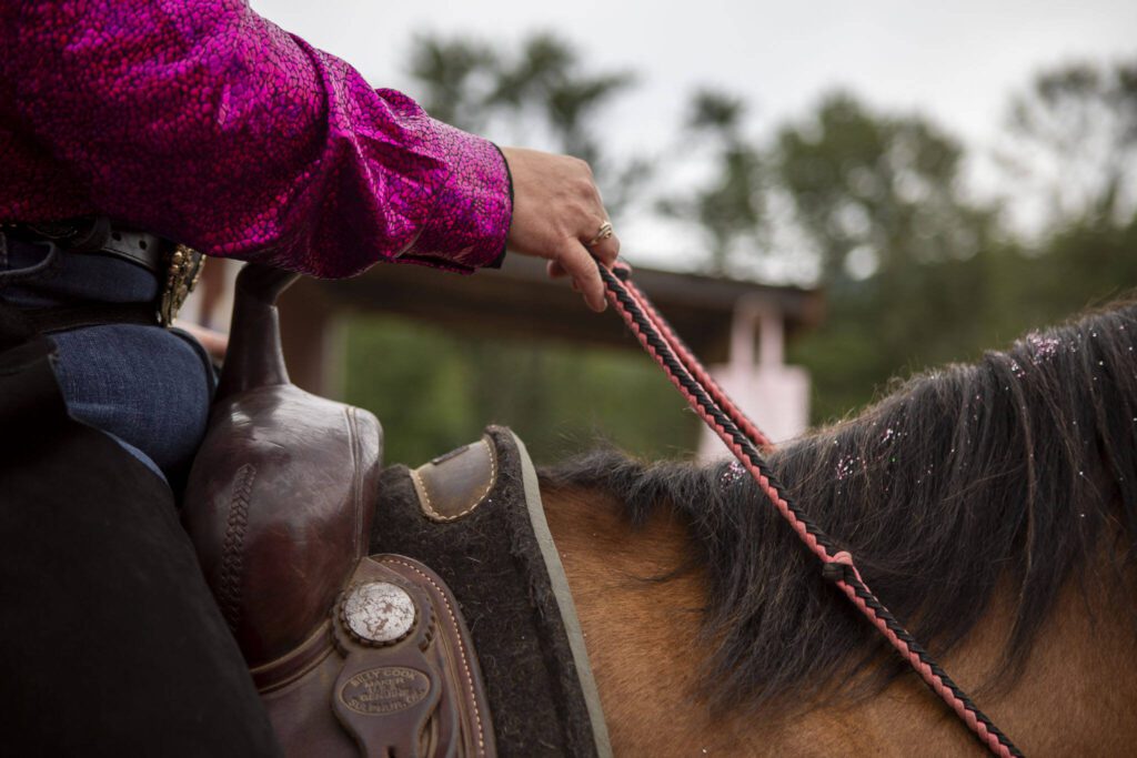 A rider guides a horse out of the arena during the Timberbowl Rodeo in Darrington, Washington, on Saturday, June 29, 2024. (Annie Barker / The Herald)
