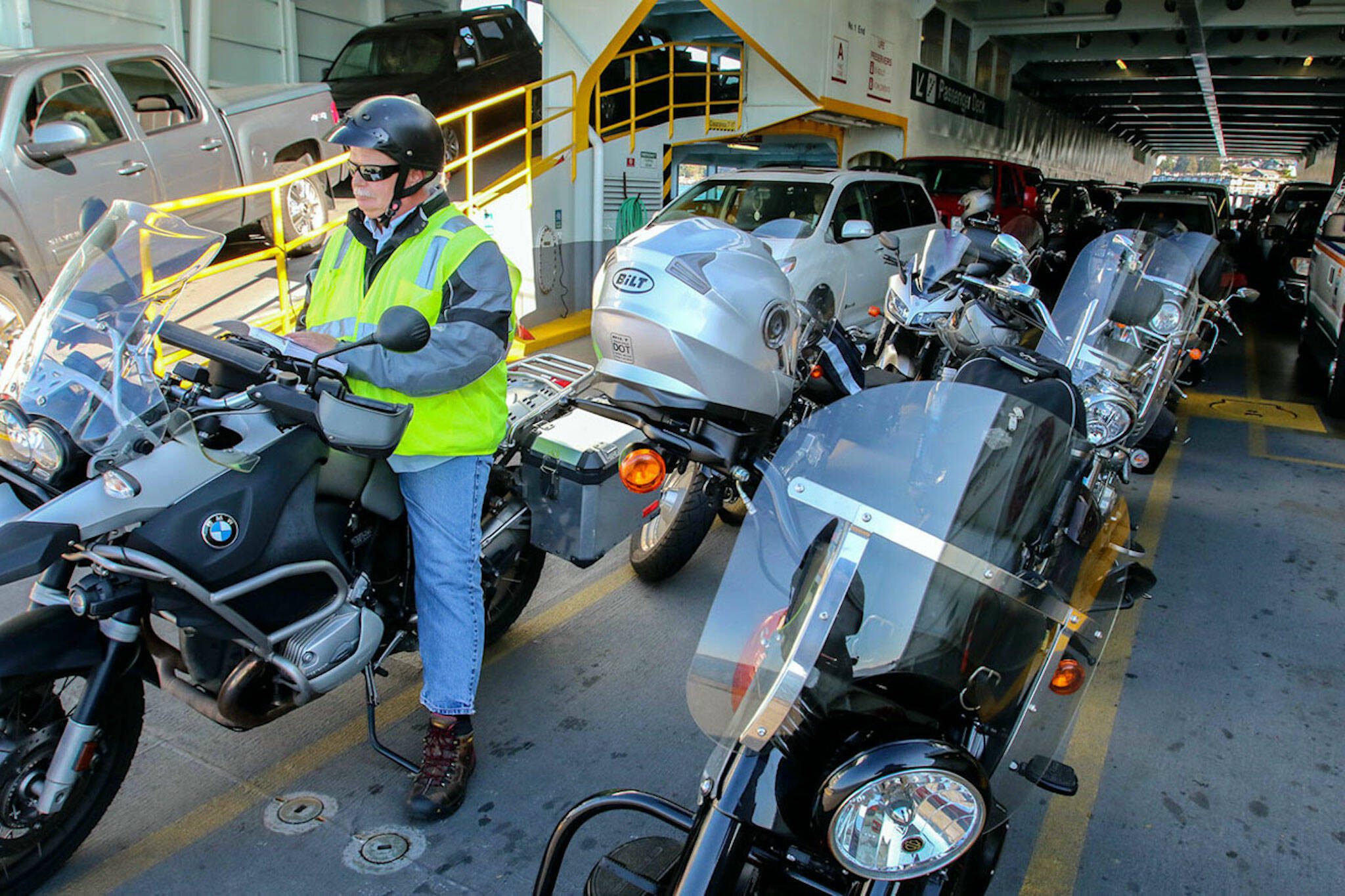 Kevin Richman reads aboard the Kitsap during the Mukilteo-Clinton run. (Kevin Clark/The Herald)