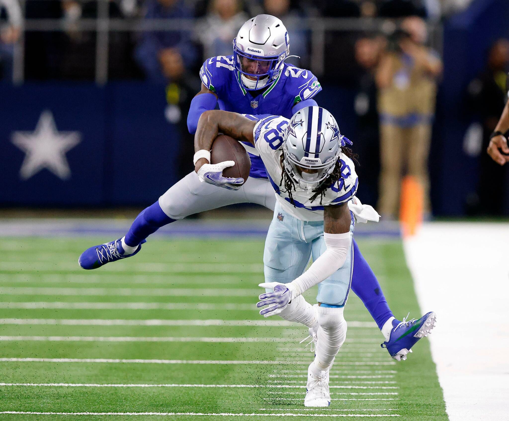 Seattle Seahawks cornerback Devon Witherspoon (21) rides Dallas Cowboys wide receiver CeeDee Lamb (88) out of bounds following a fourth quarter completion at AT&T Stadium in Arlington, Nov. 30, 2023. The Cowboys won, 41-35. (Tom Fox / Tribune News Service)