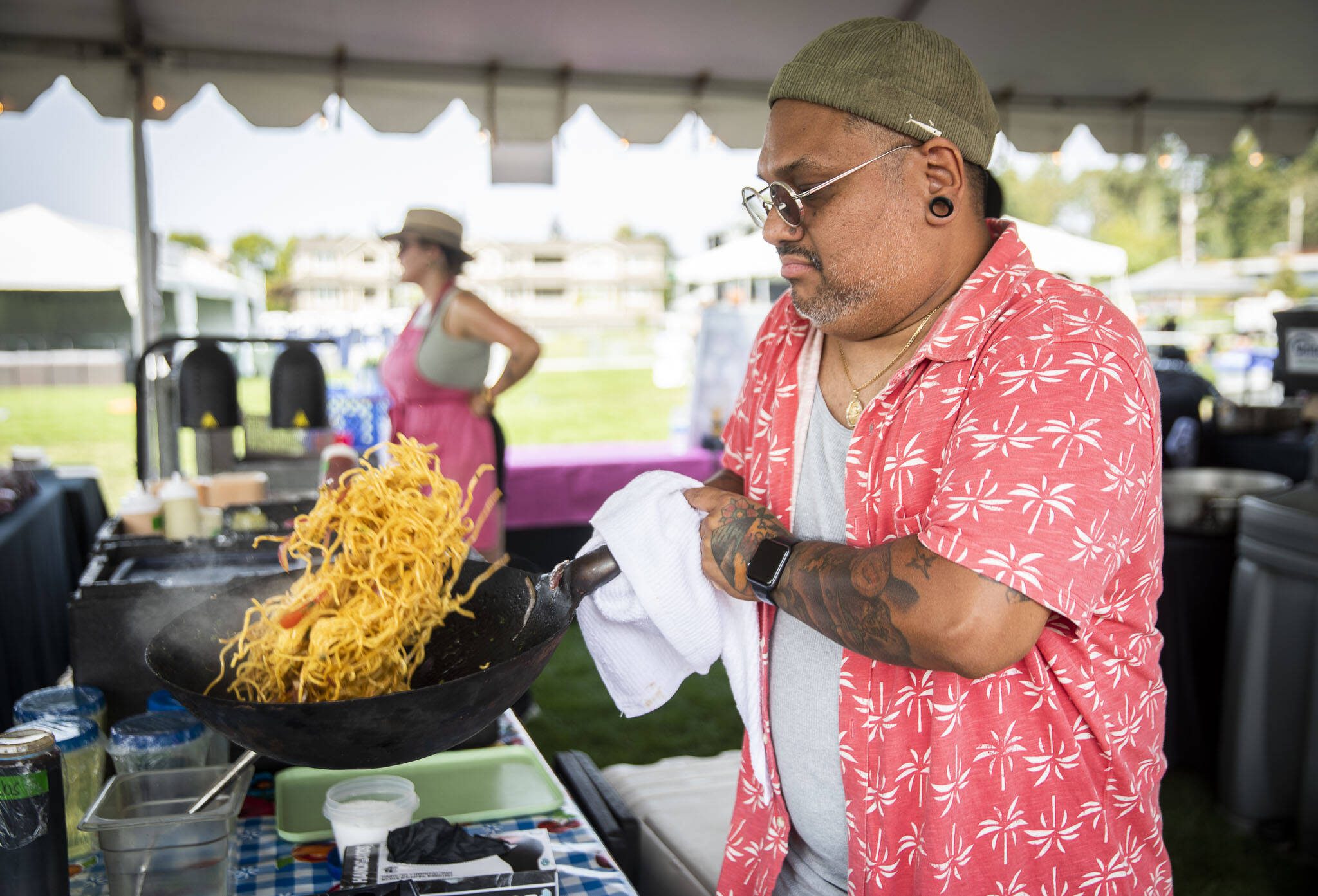 Jose Garzon cooks vegetable soba saltado at Taste Edmonds in Edmonds on Friday. (Olivia Vanni / The Herald)