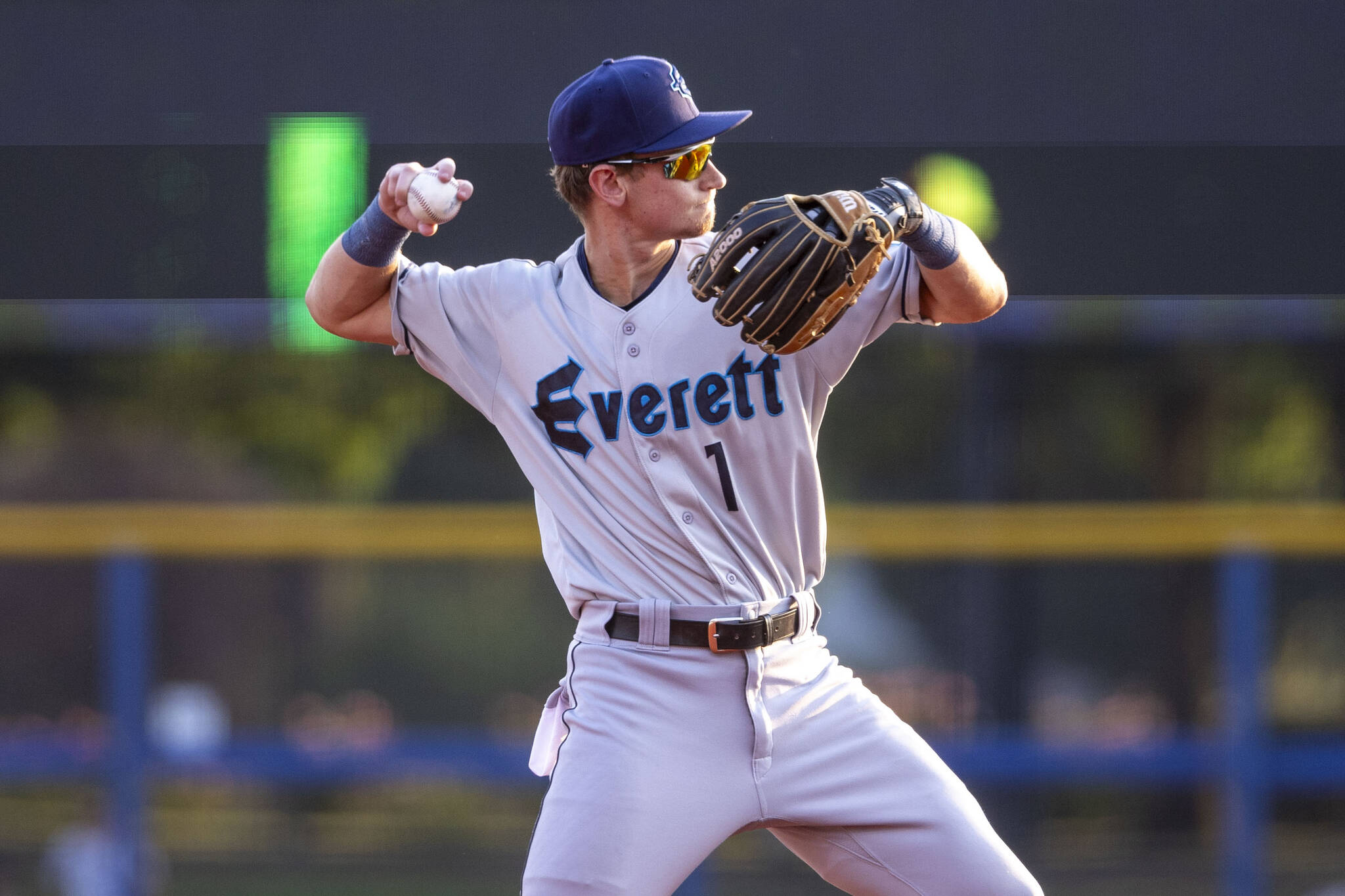 Everett AquaSox infielder Colt Emerson, the Seattle Mariners third-ranked prospect, throws a baseball to first base between innings during Everetts game against the Hillsboro Hops on August 8, 2024, at Hillsboro Ballpark in Hillsboro, Oregon. Emerson will make his Funko Field debut this week. (Photo courtesy of Evan Morud / Everett AquaSox)