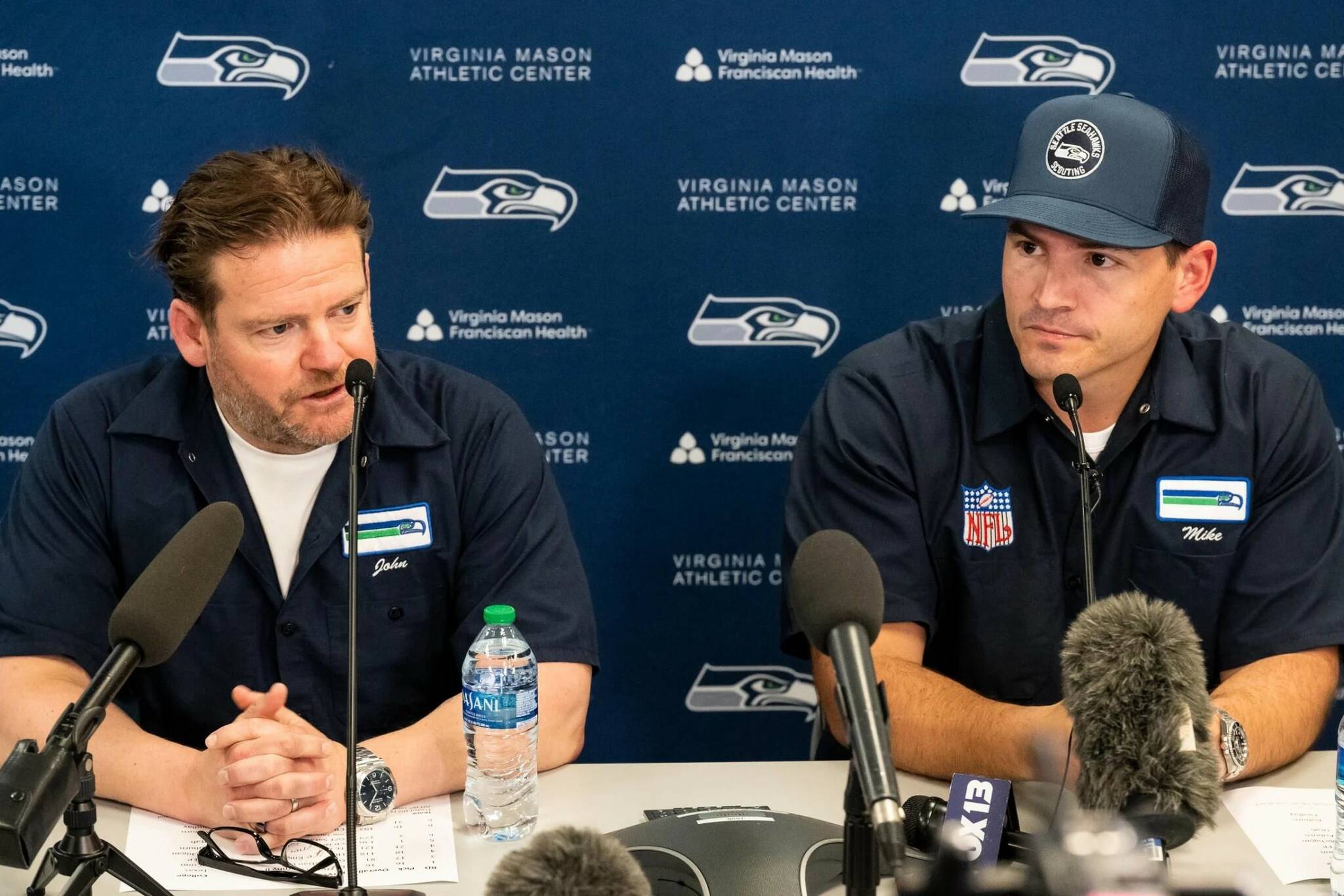 Seattle Seahawks general manager John Schneider (left) and head coach Mike Macdonald speak during a press conference at the Virginia Mason Athletic Complex on April 27, 2024. (Photo courtesy of Seattle Seahawks)