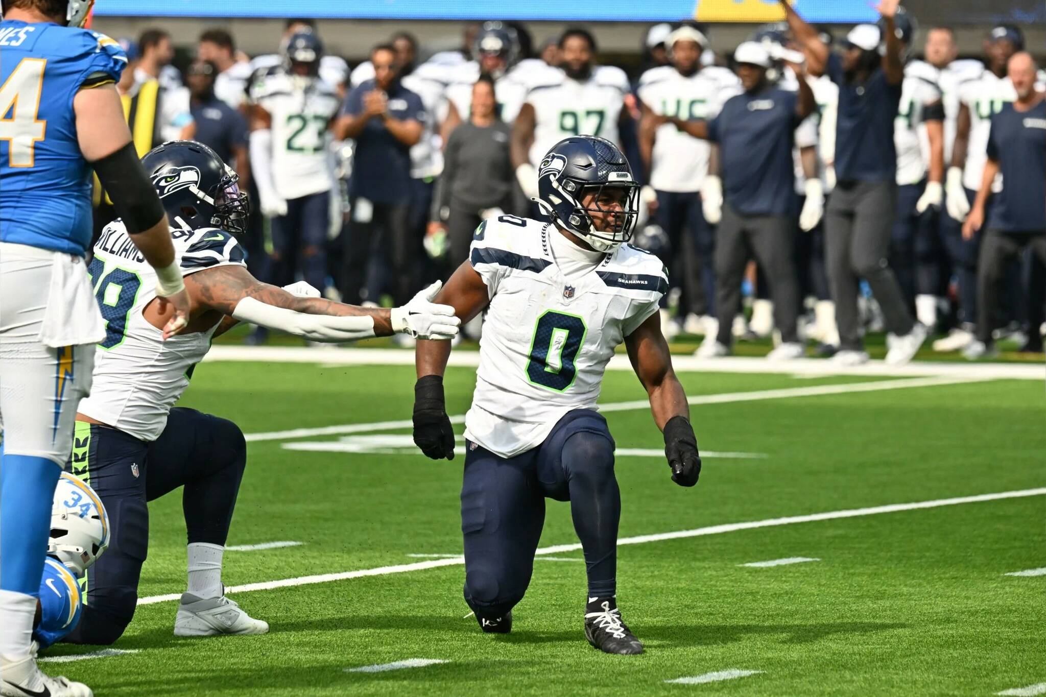 Seahawks starting middle linebacker Tyrel Dodson, who will wear the communication device that receives play calls from coach Mike Macdonald, reacts to a play in a preseason game against the Los Angeles Chargers at SoFi Stadium on Aug. 10, 2024. (Photo courtesy of Edwin Hooper / Seattle Seahawks)