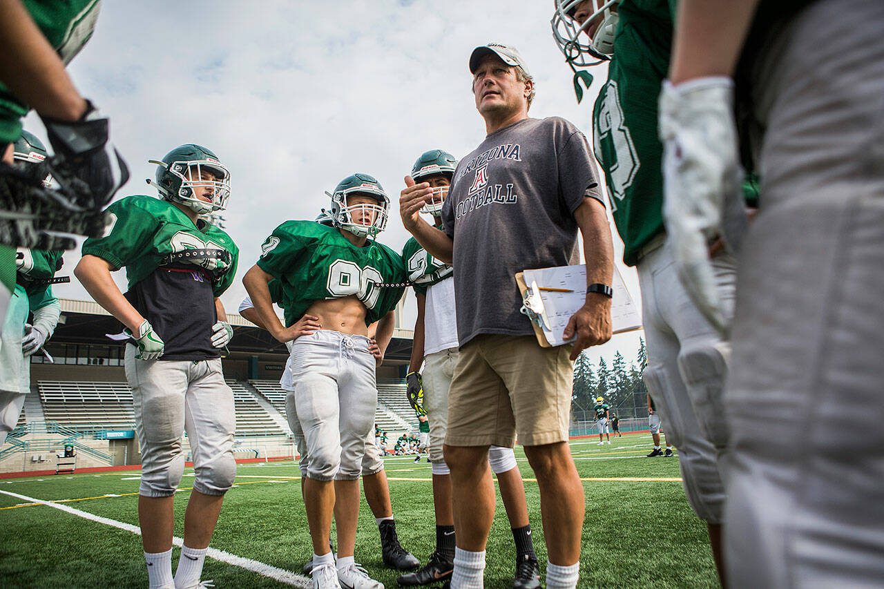 Edmonds-Woodway coach John Gradwohl talks to his players during Edmonds-Woodway High School football practice on Aug. 24, 2018 in Edmonds, Wash. (Olivia Vanni / The Herald)