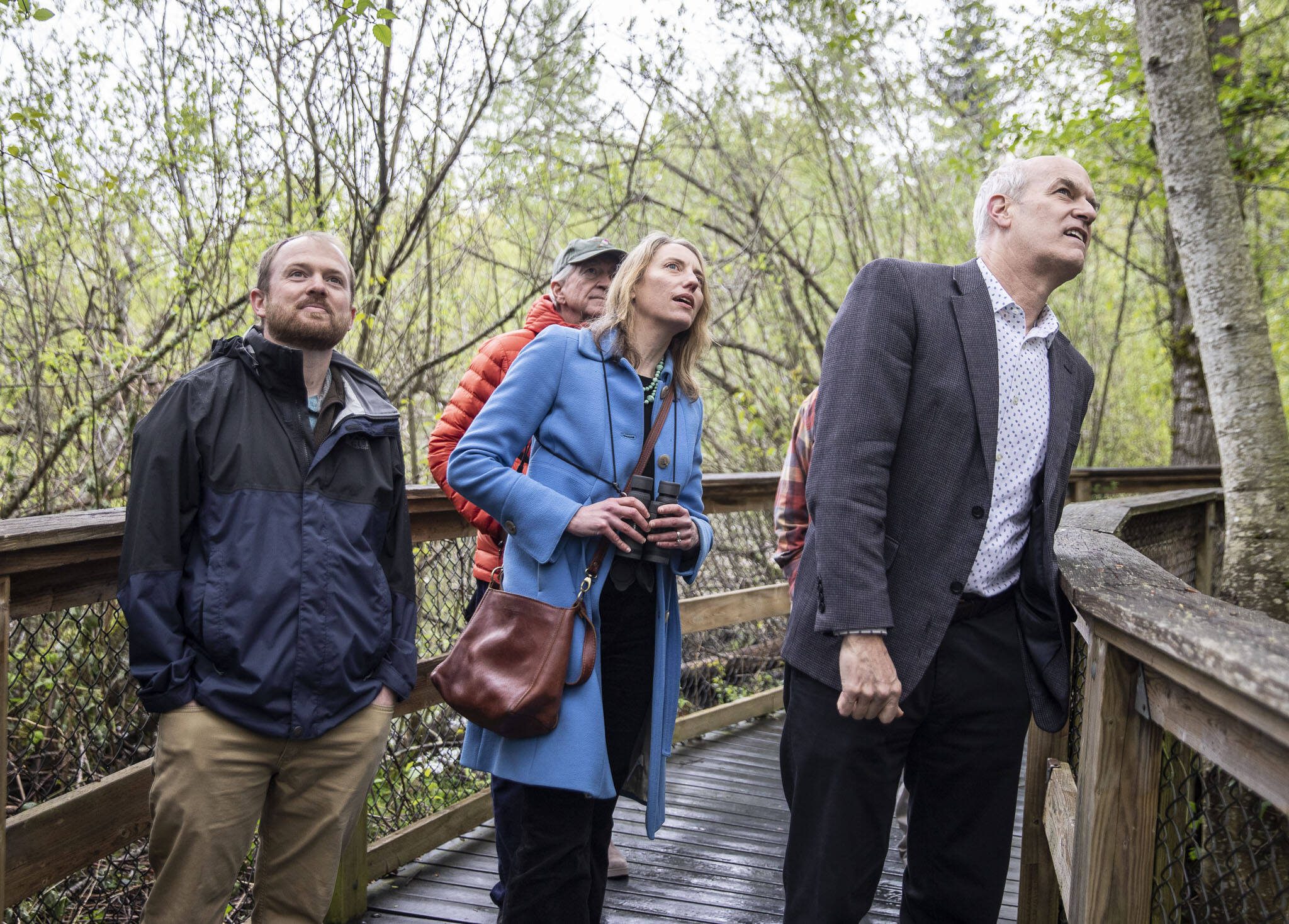 U.S. Rep. Rick Larsen, D-Wash. (right), with Pilchuck Audubon Executive Director Brian Zinke and Audubon Washington Interim Executive Director Dr. Trina Bayard look up at a bird while walking in the Narcbeck Wetland Sanctuary in April in Everett, marking reauthorization of the migratory bird act. (Olivia Vanni / The Herald file photo)