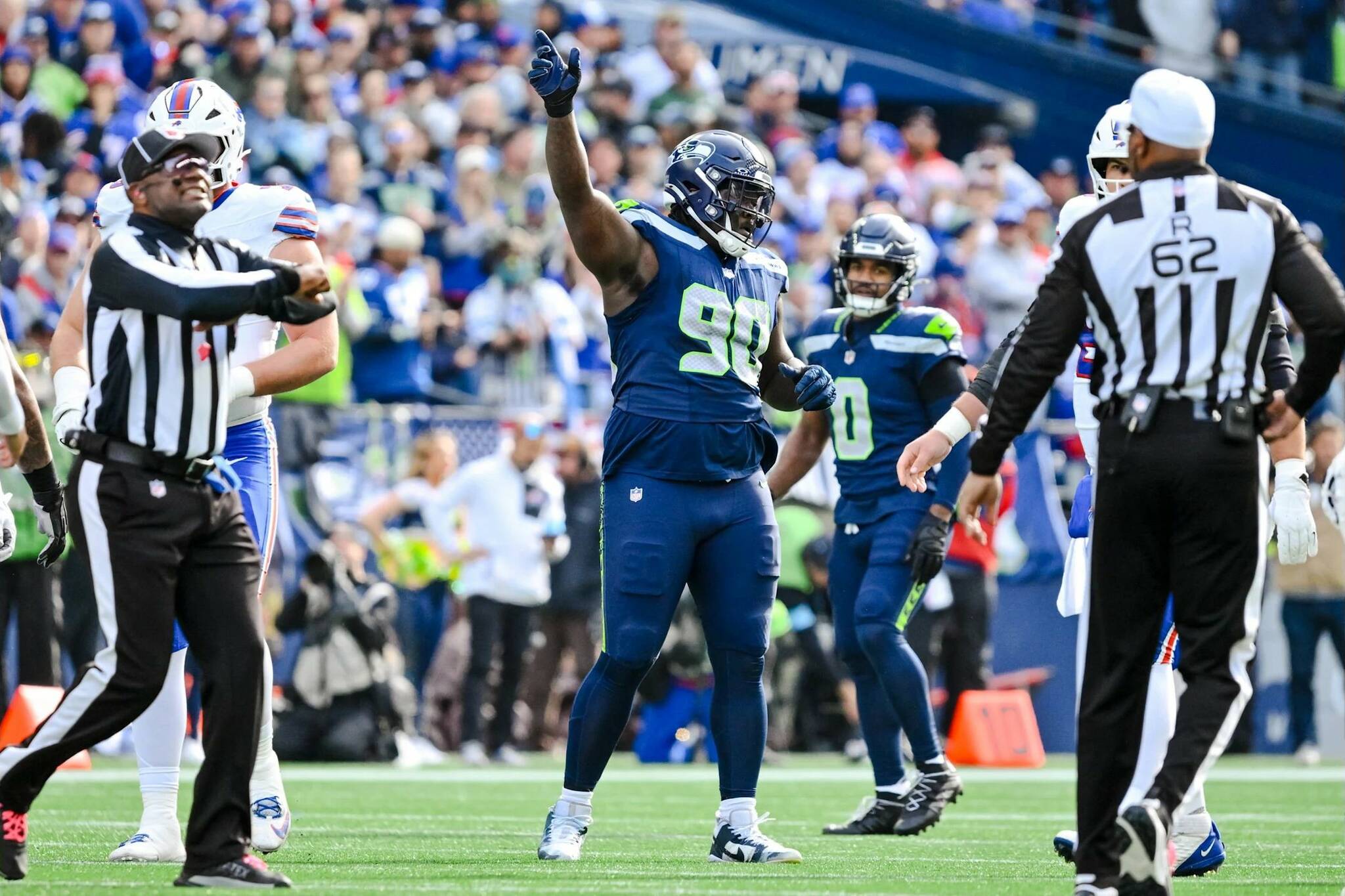 Seahawks defensive lineman Jarran Reed (90), who was in involved in a scuffle with teammate Derick Hall during Sunday's game, reacts to a false start penalty against the Buffalo Bills at Lumen Field on Oct. 27, 2024.