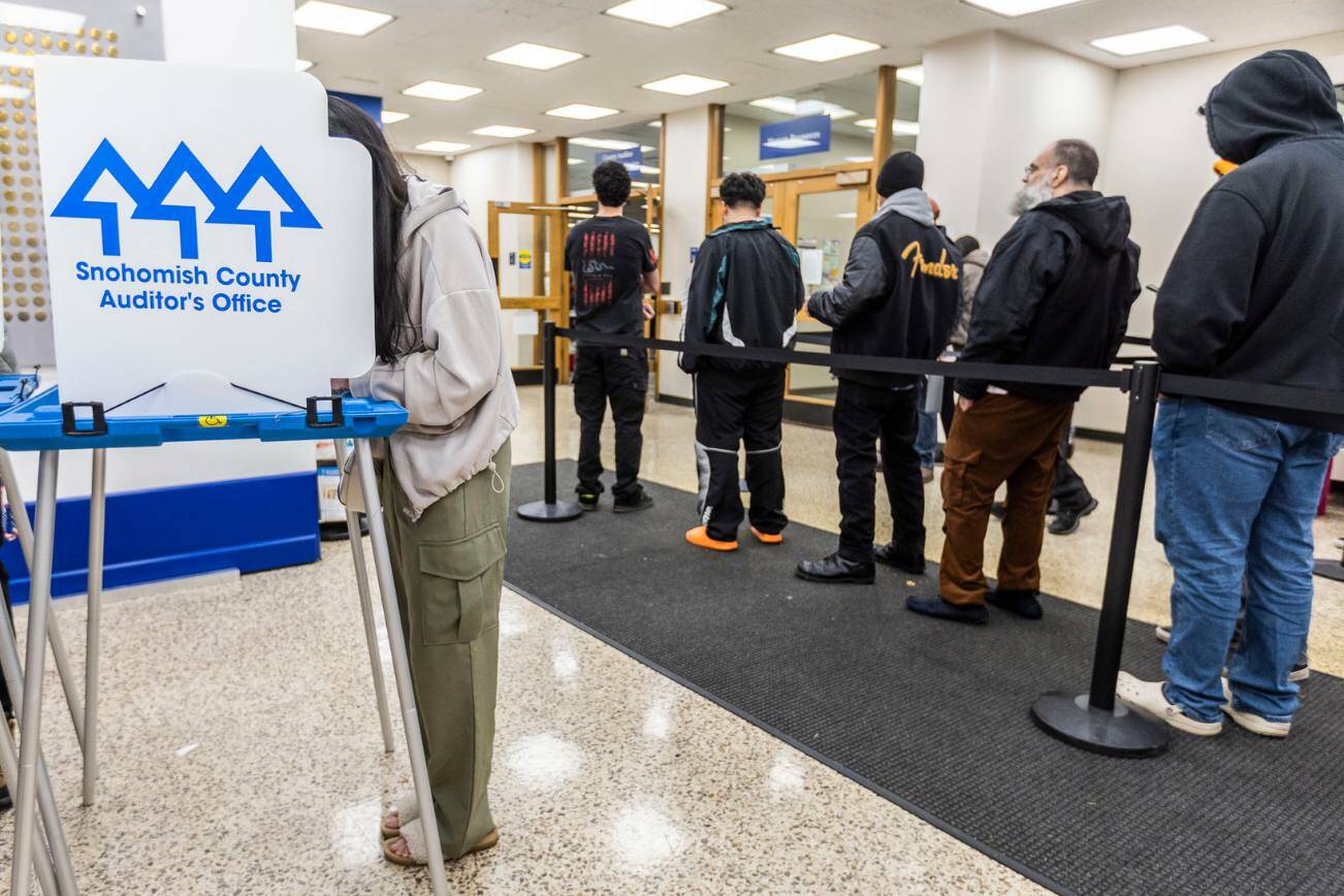 Nora Xue, 24, fills out her ballot at the Snohomish County Auditor’s Office on Tuesday in Everett, Washington. (Olivia Vanni / The Herald)