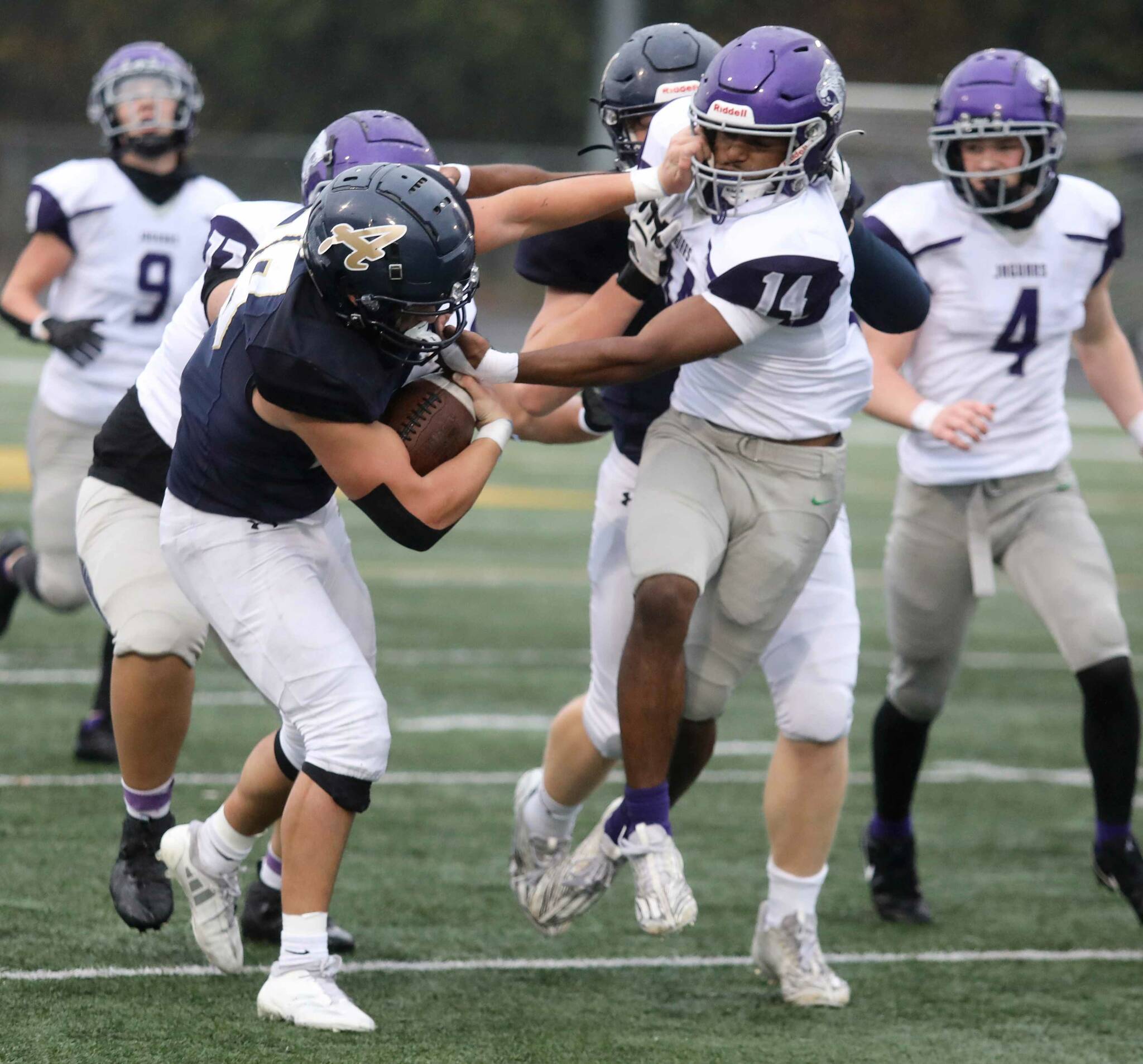 Arlington senior running back Caleb Reed stiff arms a North Creek player during a district winner-to-state, loser-out Round of 32 game at John C. Larson Stadium in Arlington, Wash., on Saturday, Nov. 9, 2024. The Eagles won 56-35. (Taras McCurdie / The Herald)